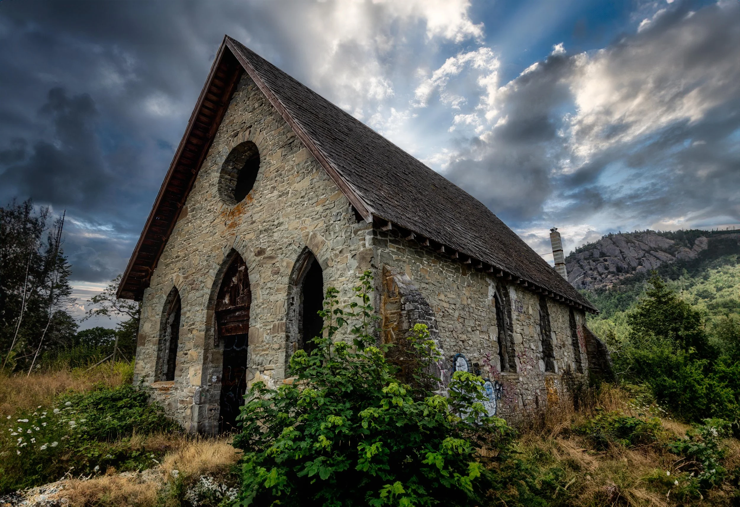 Historic Butter Stone Church exterior on Vancouver Island, with Mount Tzouhalem in the background.