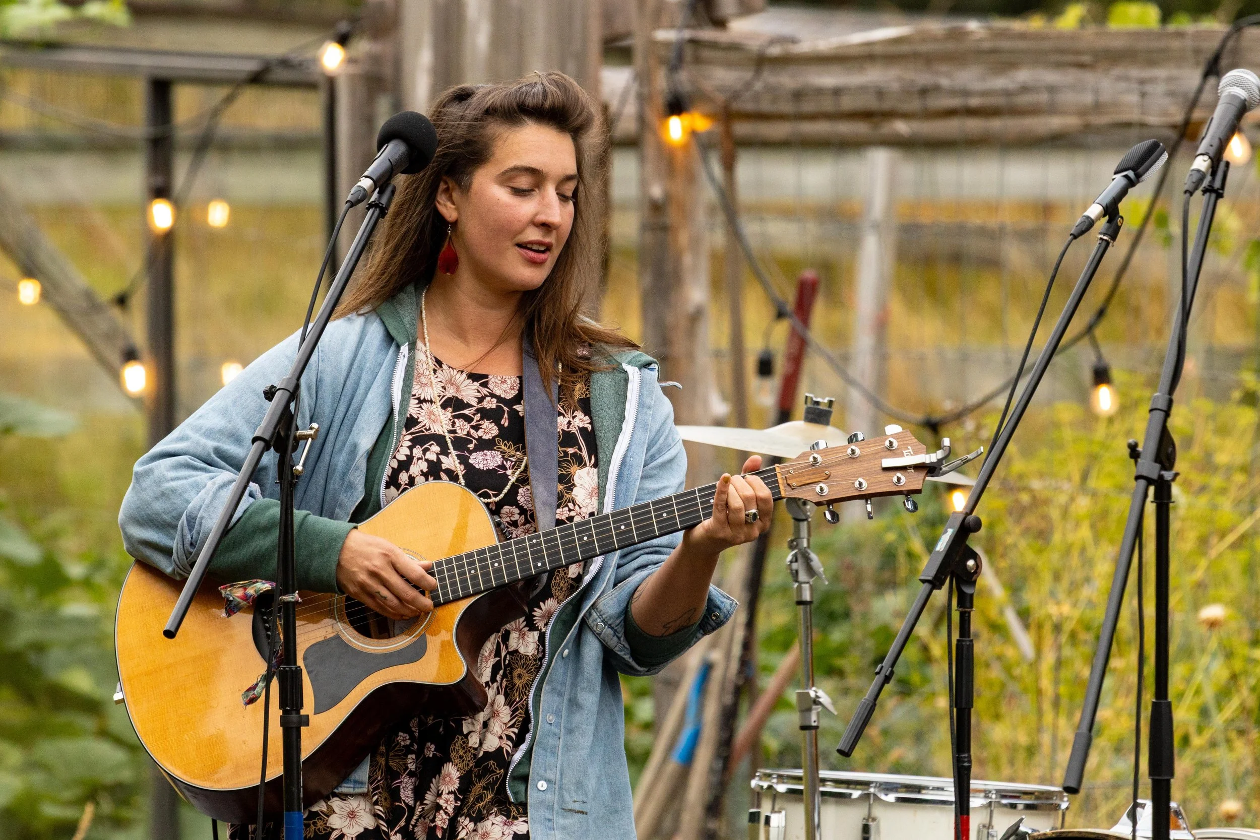Portrait of a woman singing and playing acoustic guitar at an outdoor event - Dylan Phillips Photography, Vancouver Island B.C