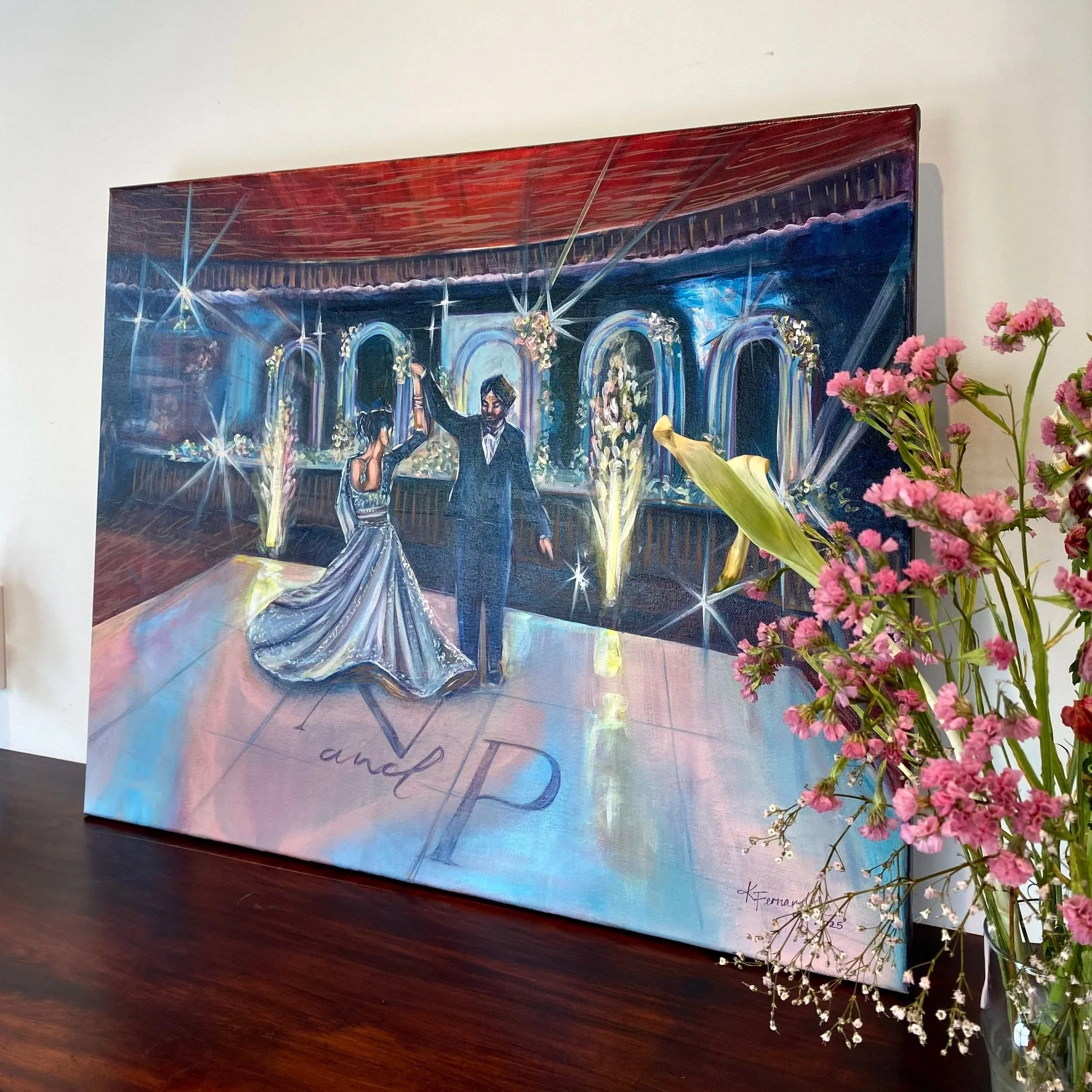Live Wedding Painting of a bride and groom dancing at their wedding reception with pink flowers in a vase nearby.
