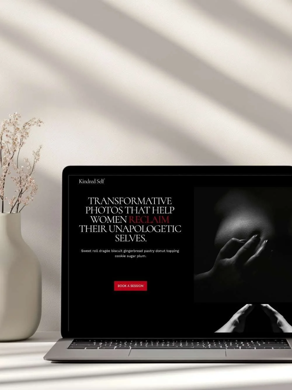 Laptop screen displaying the Kindred Self Squarespace 7.1 website template, showing the hero section with an artistic silhouette image and the headline “Transformative photos that help women reclaim their unapologetic selves” and a red CTA.