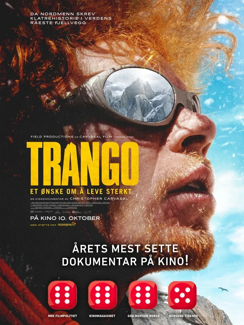 Plakat for dokumentarfilmen "Trango" med en person med rødt hår og skjegg, iført briller med utsikt over fjell, med snø og blå himmel i bakgrunnen.