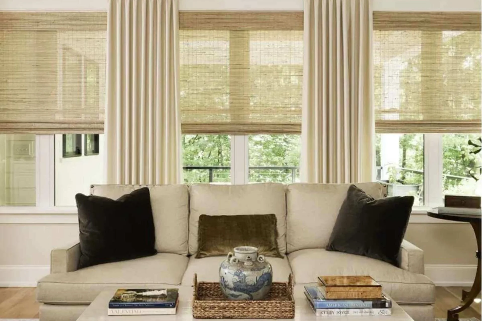 Woven wood window treatments on three windows in a living room.
