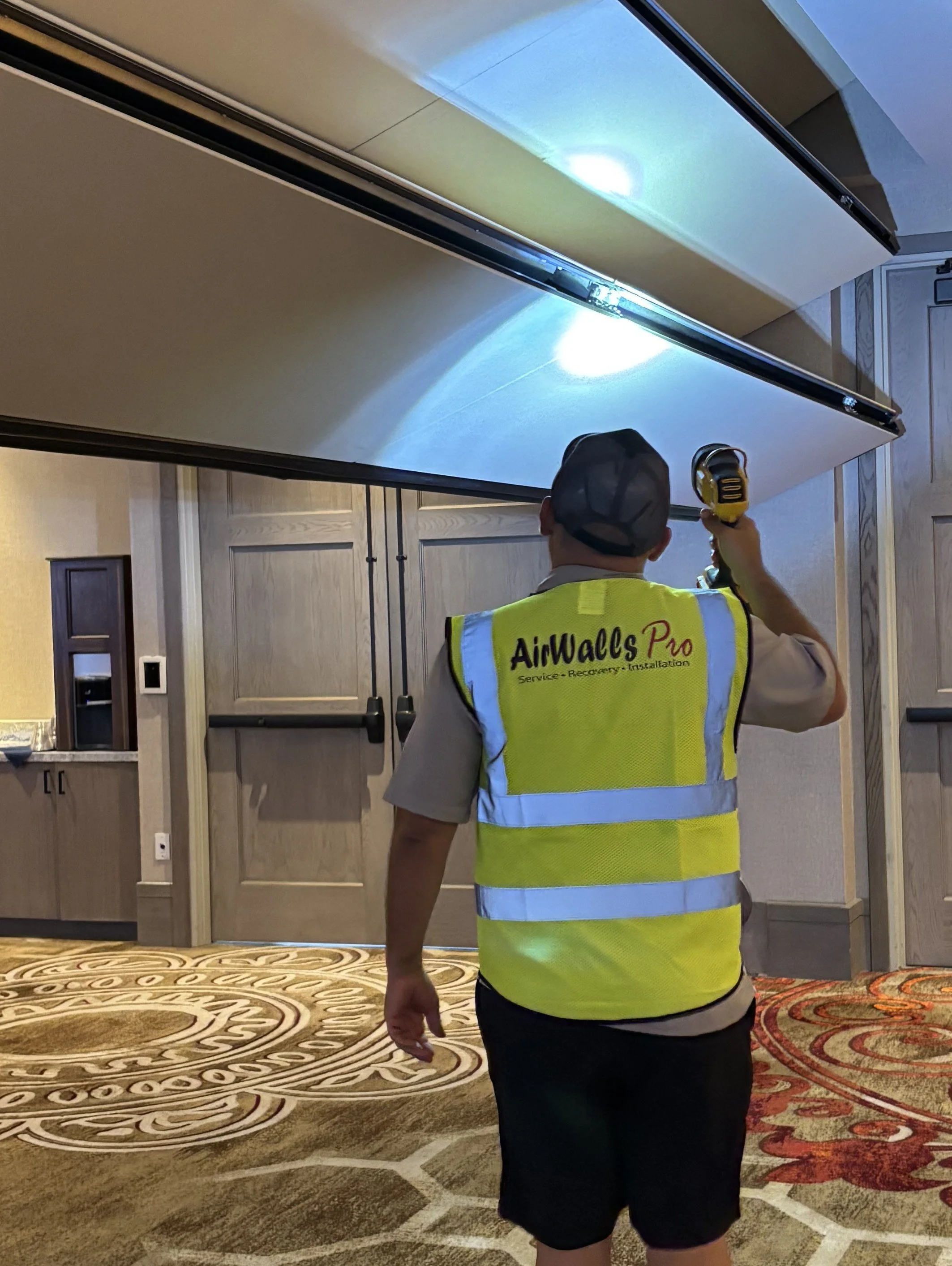 Operable partition maintenance technician at work