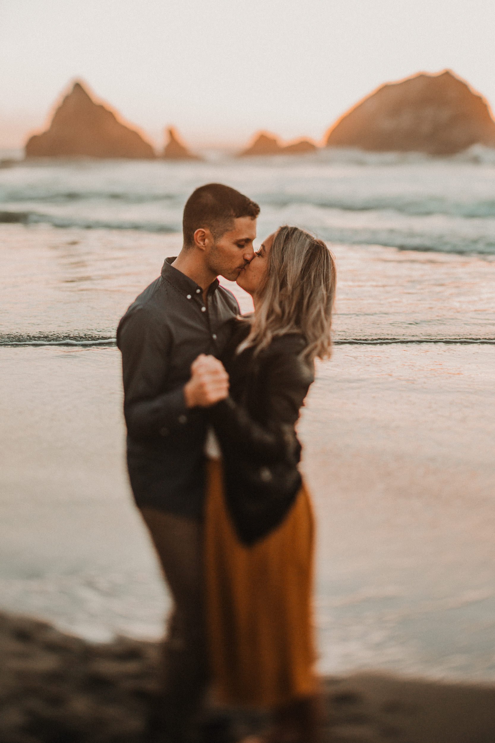 couple kissing oceanside coastal maine engagement