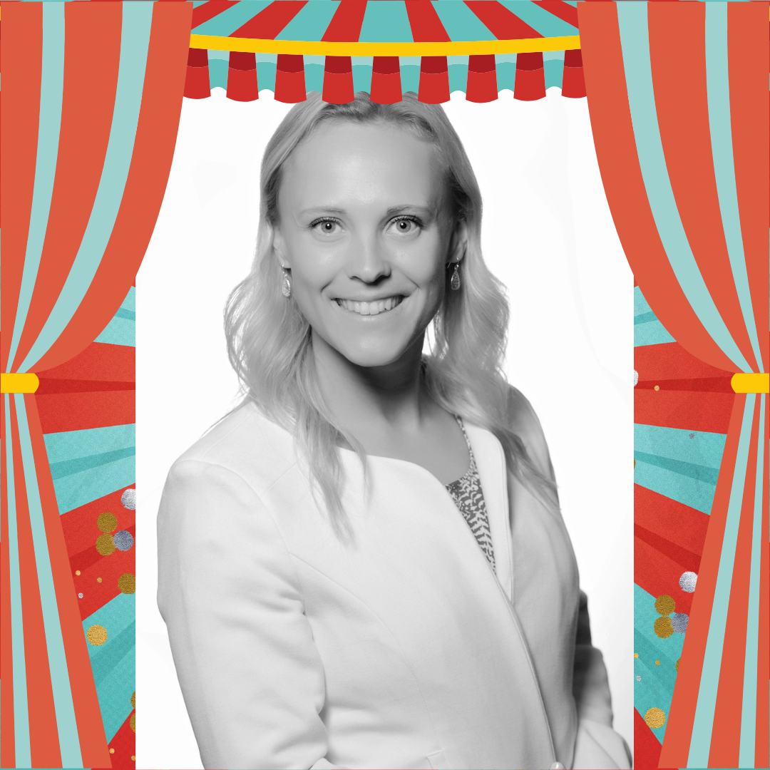 A black and white photo of a woman smiling into the camera.