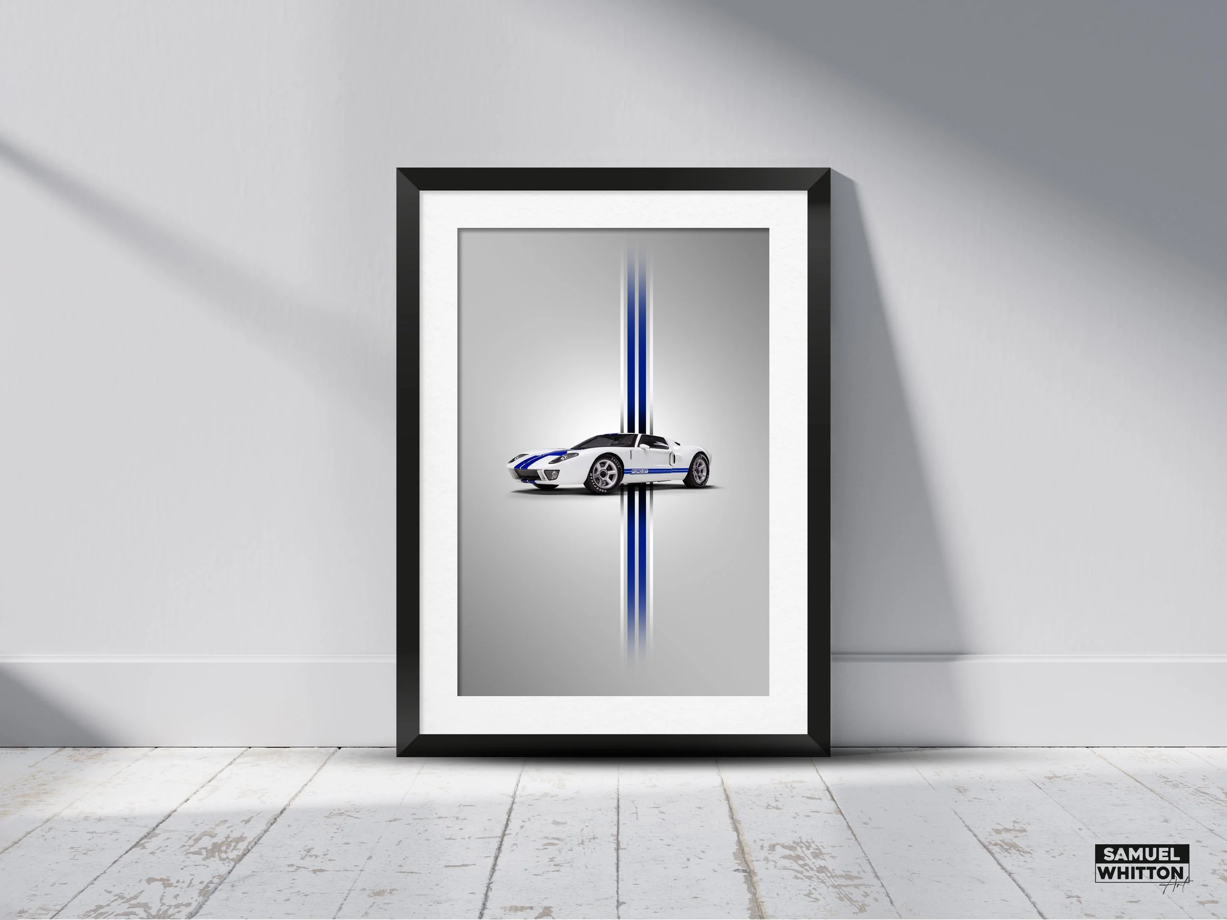 Framed art print featuring a white sports car with blue racing stripes, set against a gray background, displayed on a wooden floor.
