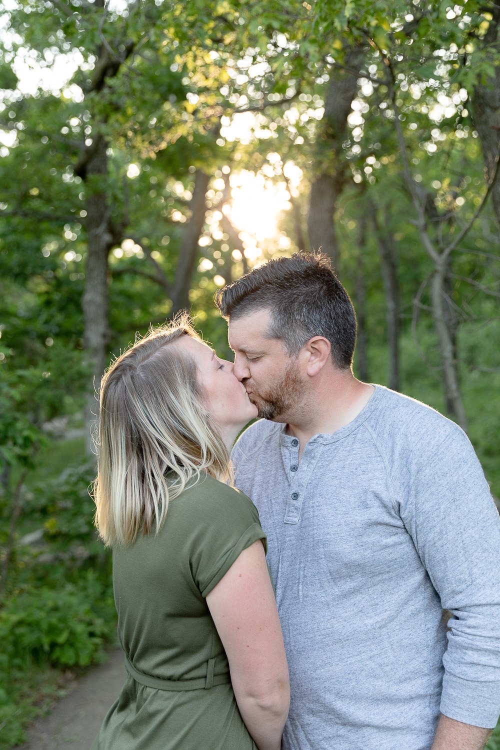 Couple kissing during family photos at Devils Lake State Park