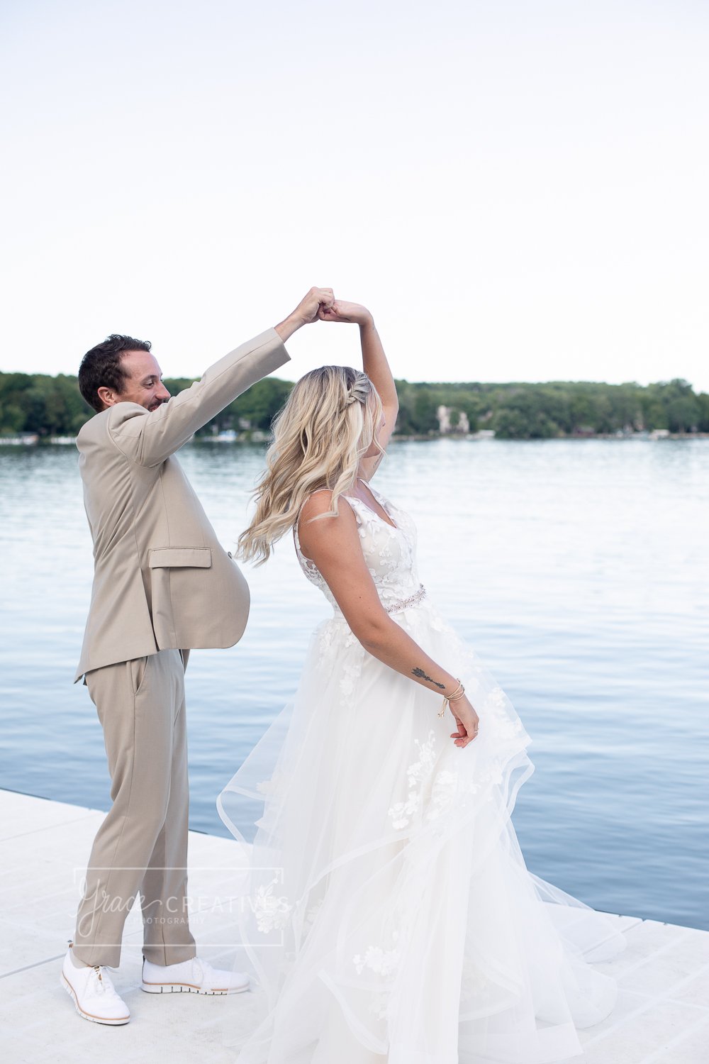 Bride being twirled by the groom on the dock at Cenequa country Club