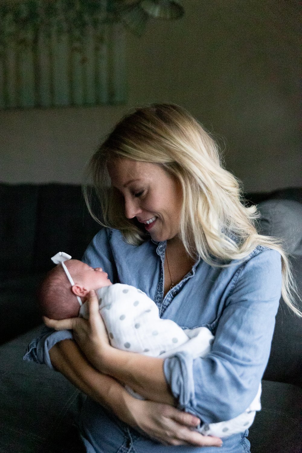 Mother holds her twin daughter