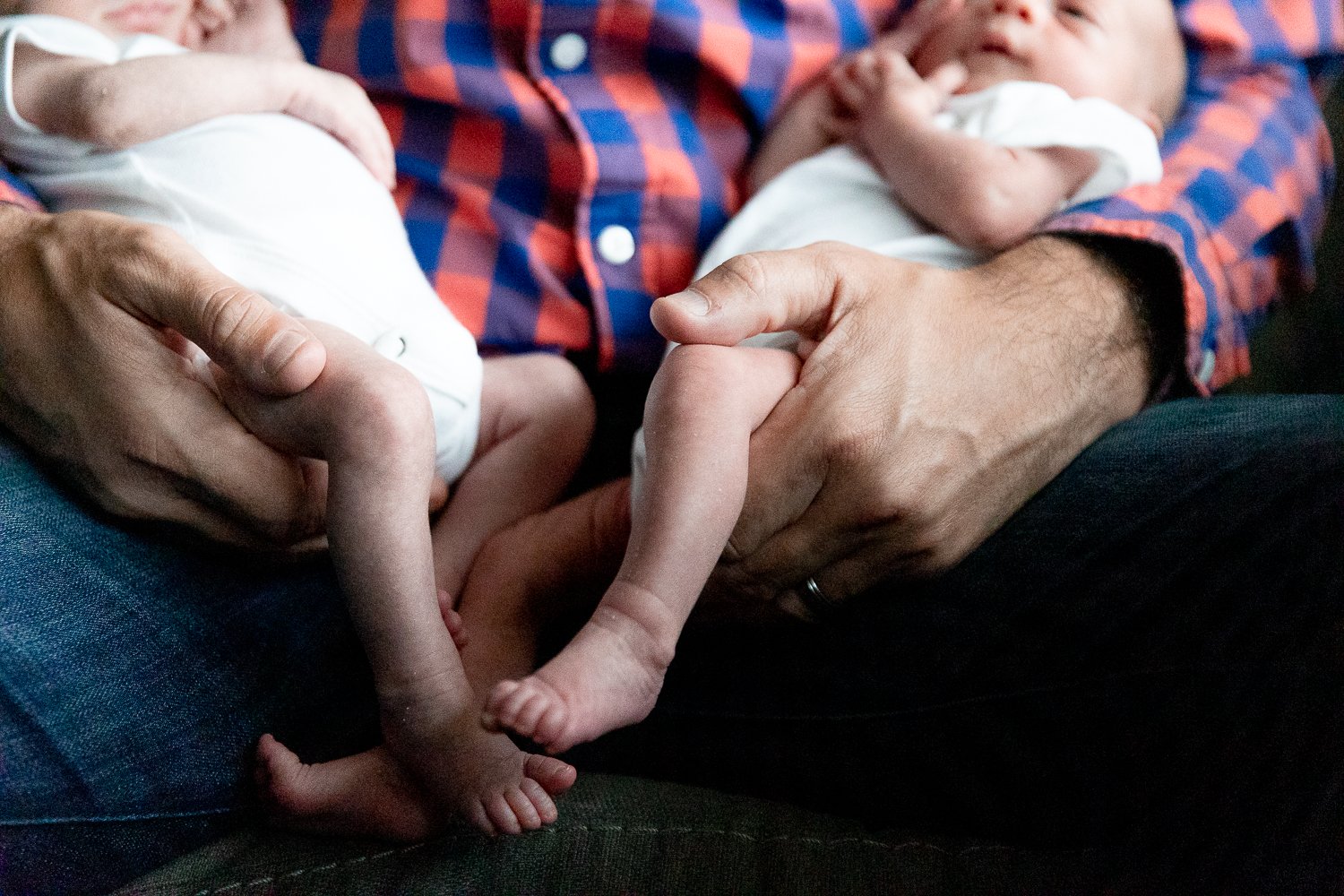 Newborn twins tiny legs, feet and toes
