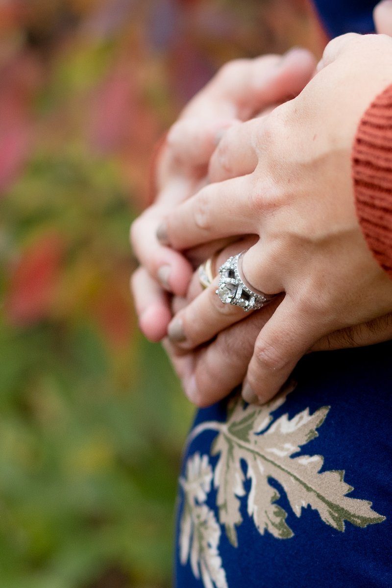 closeup of wedding ring and baby bump during a Fall Maternity Session at Fox Brook Park in Brookfield with Grace Creatives photography