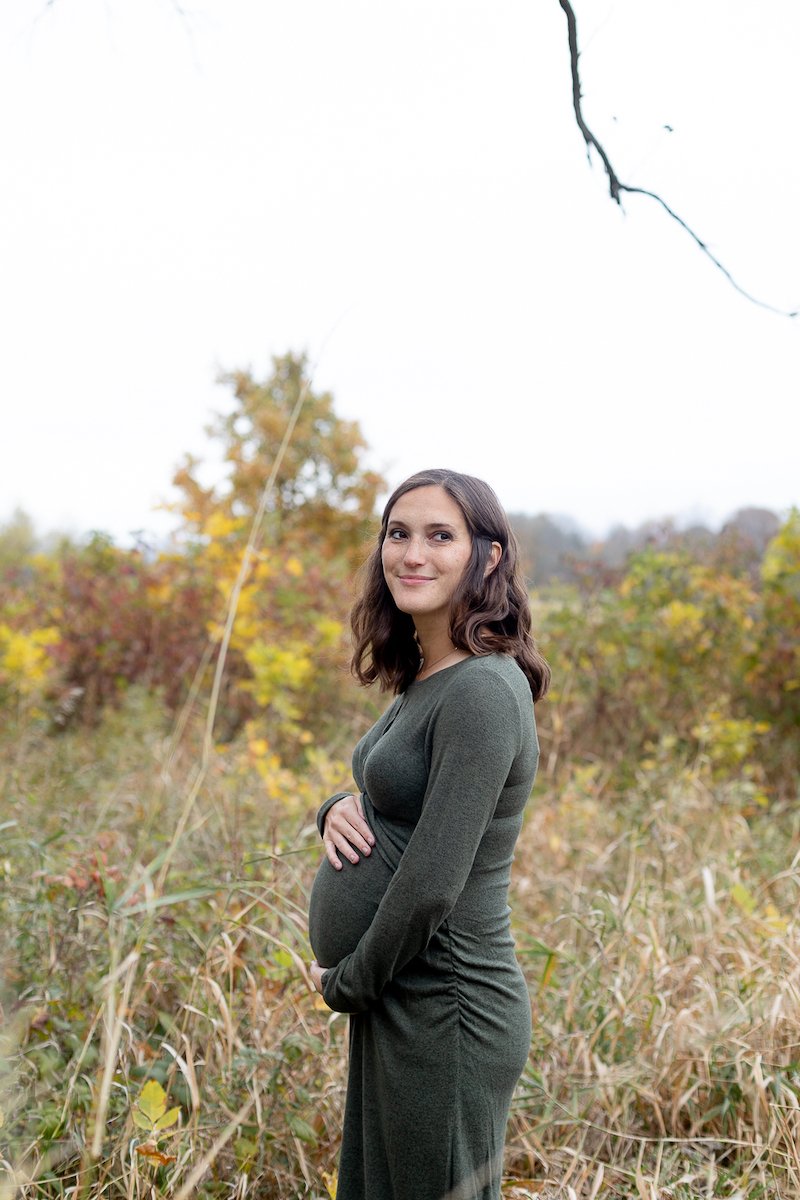 new mother smiling during a Fall Maternity Session at Fox Brook Park in Brookfield with Grace Creatives photography
