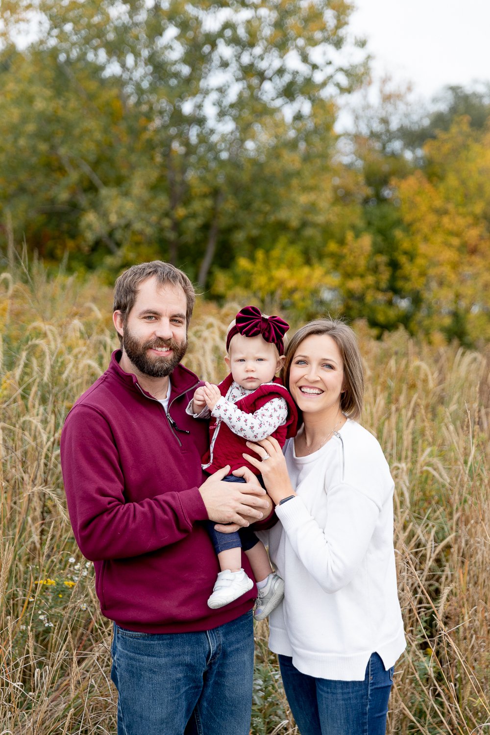family of three standing in long grasses during fall 2020 mini sessions