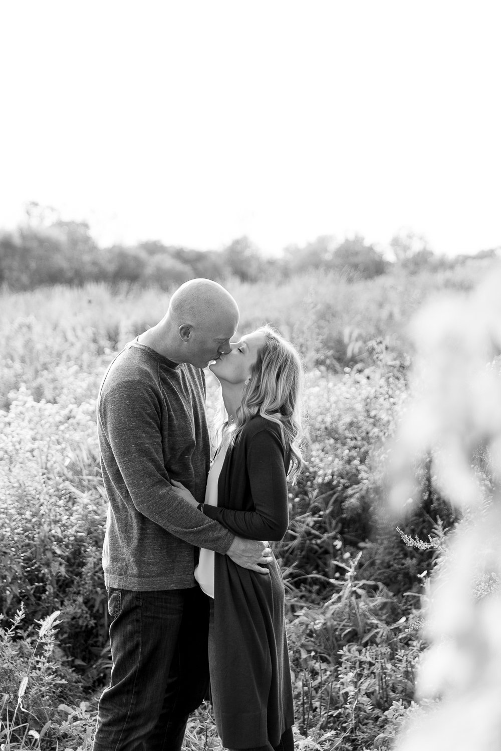 black and white photo of couple kissing during brookfield family photos at Hartung park with grace creatives photography