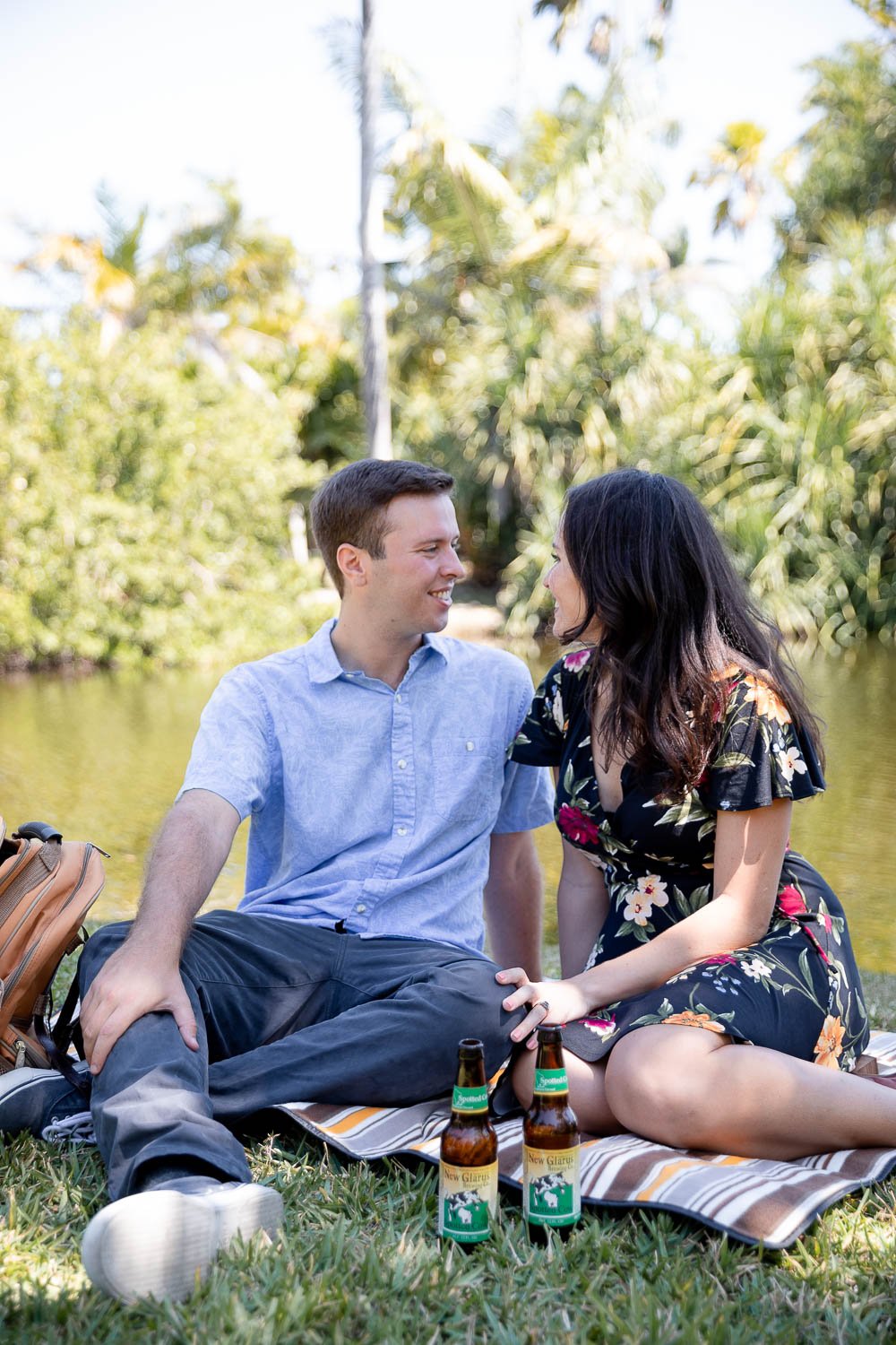 man and woman drinking New Glarus Spotted Cow during engagement session