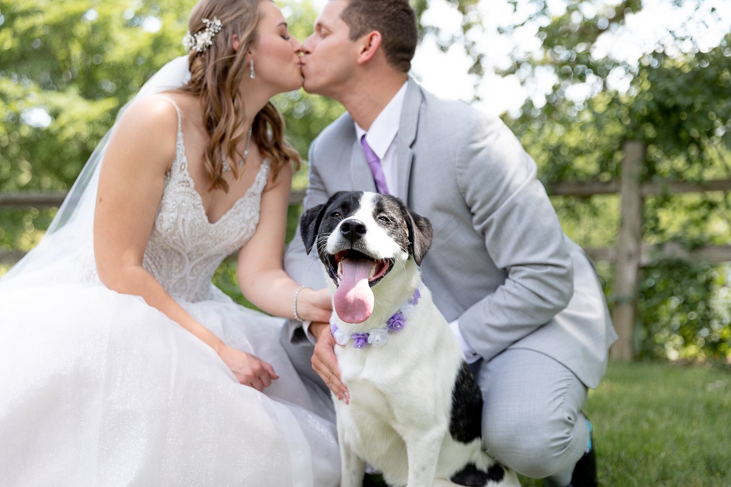 couple with their dog at grand geneva summer wedding