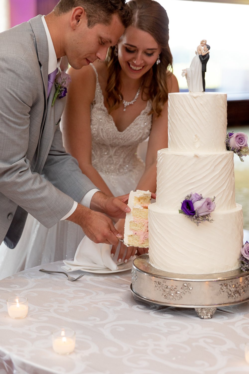 bride and groom cutting cake at Summer Wedding at Grand Geneva