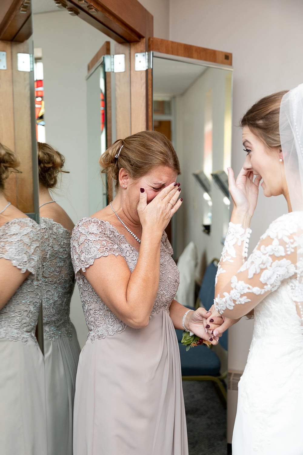 bride and mother getting ready in catholic church