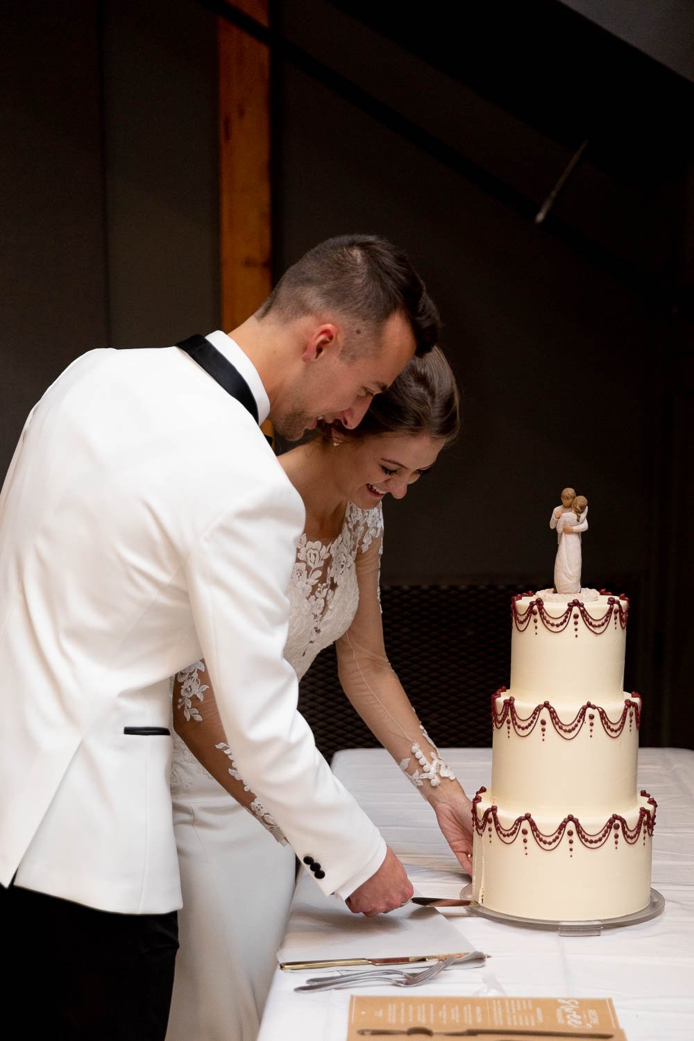 couple cutting cake at fall fete of wales wedding