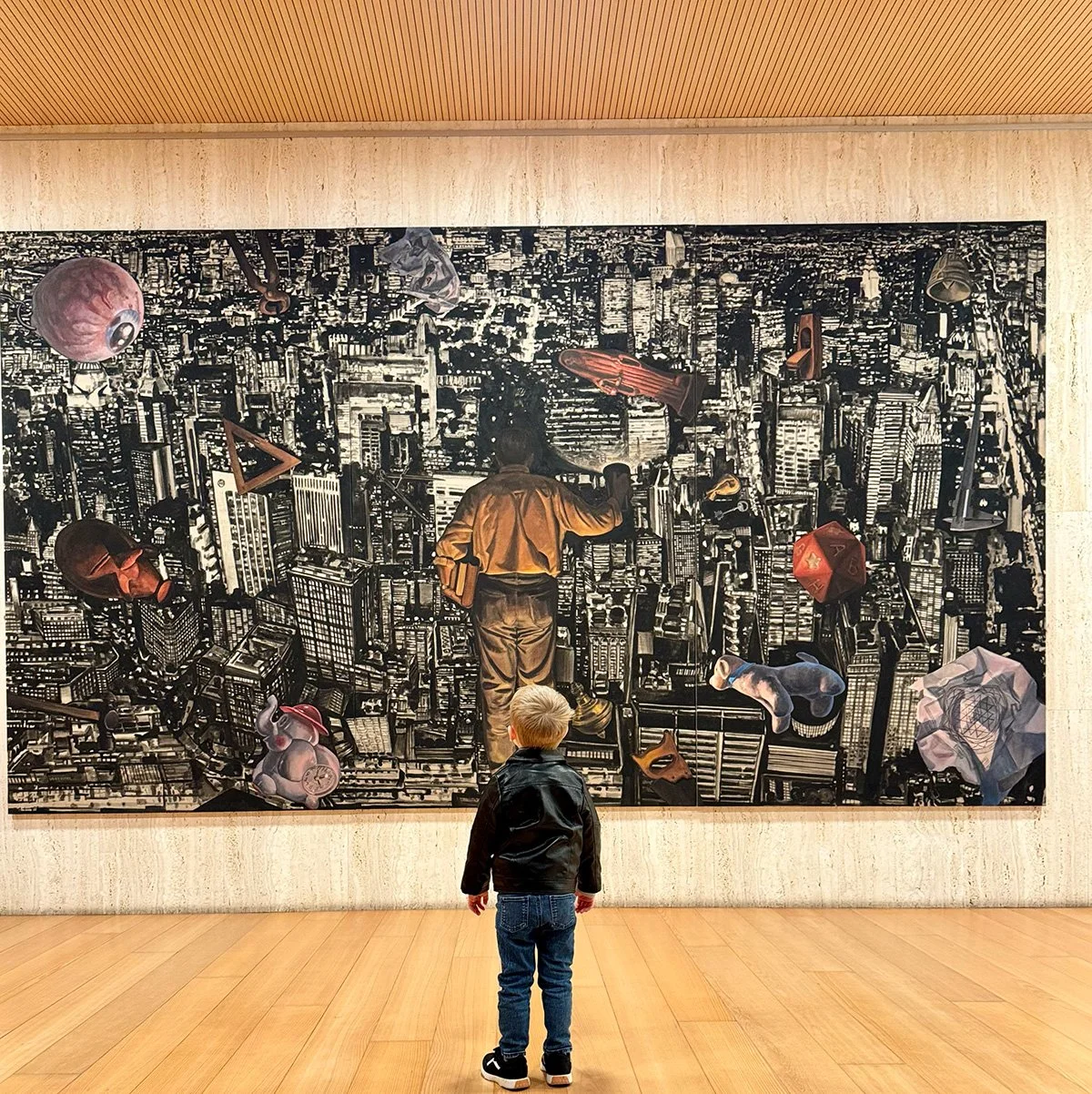 A young child standing in front of a large contemporary painting in a museum, reflecting curiosity, creativity, and the everyday moments that shape motherhood.
