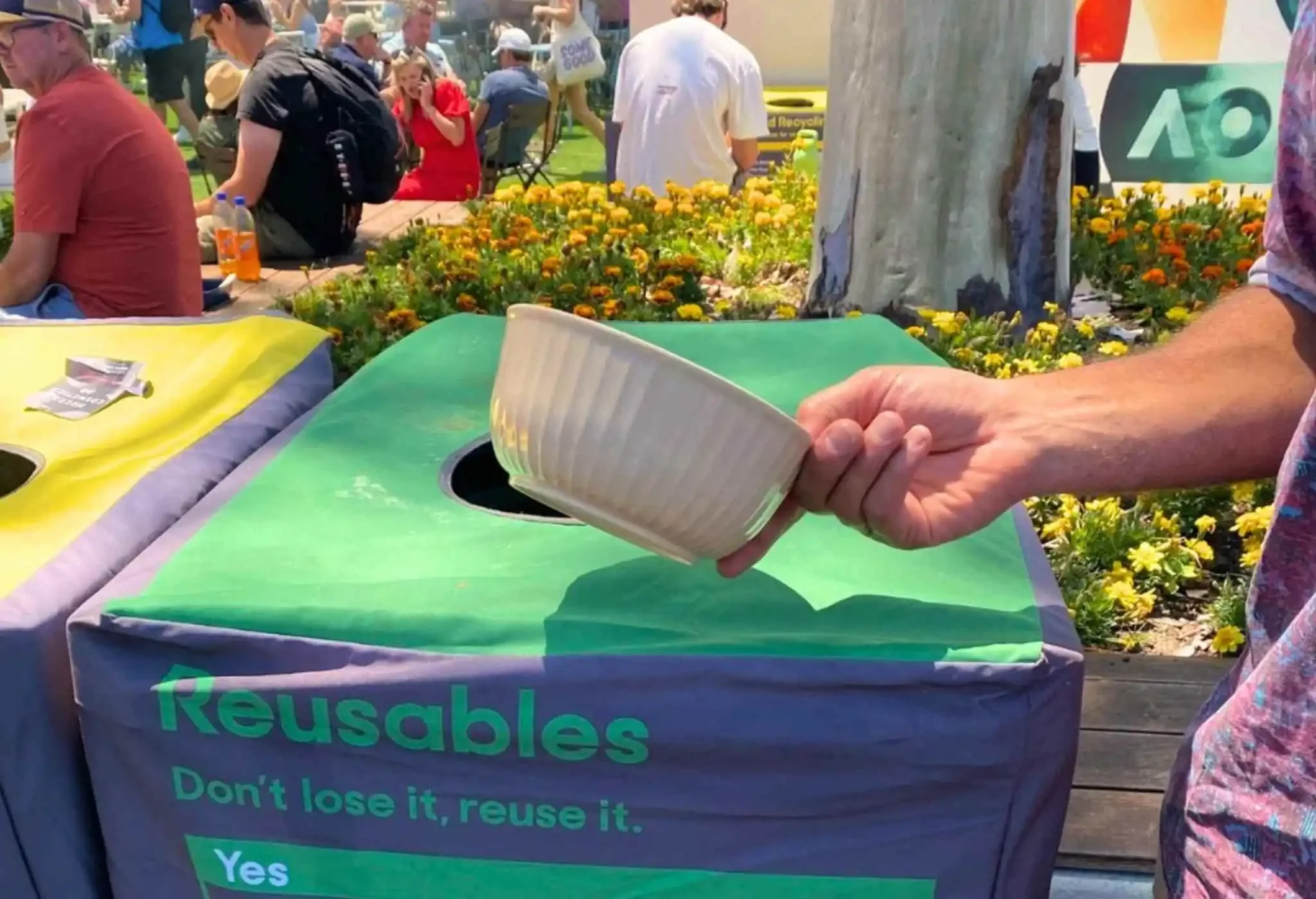Patron returning a Green My Plate reusable food bowl at the Australian Open reusable return station.