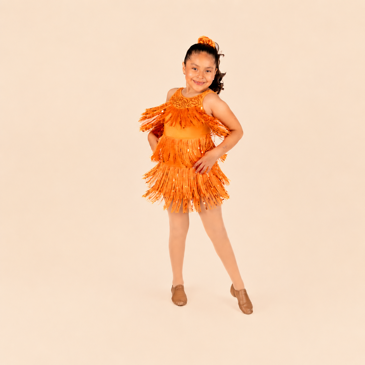 Young dancer in orange costume at Ignite Dance Center in Henderson, Nevada