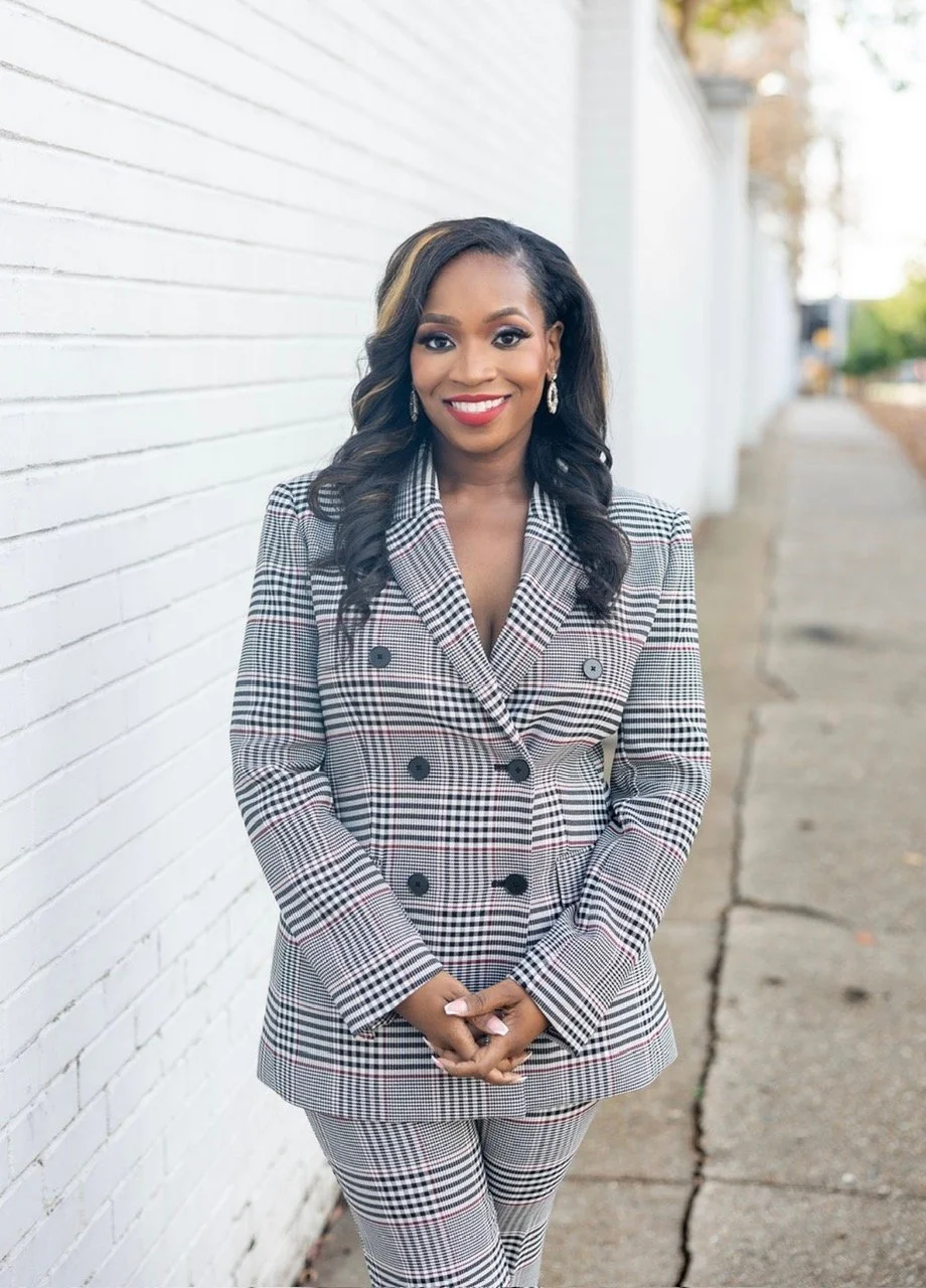 Woman in red and blue posing in front of capitol.