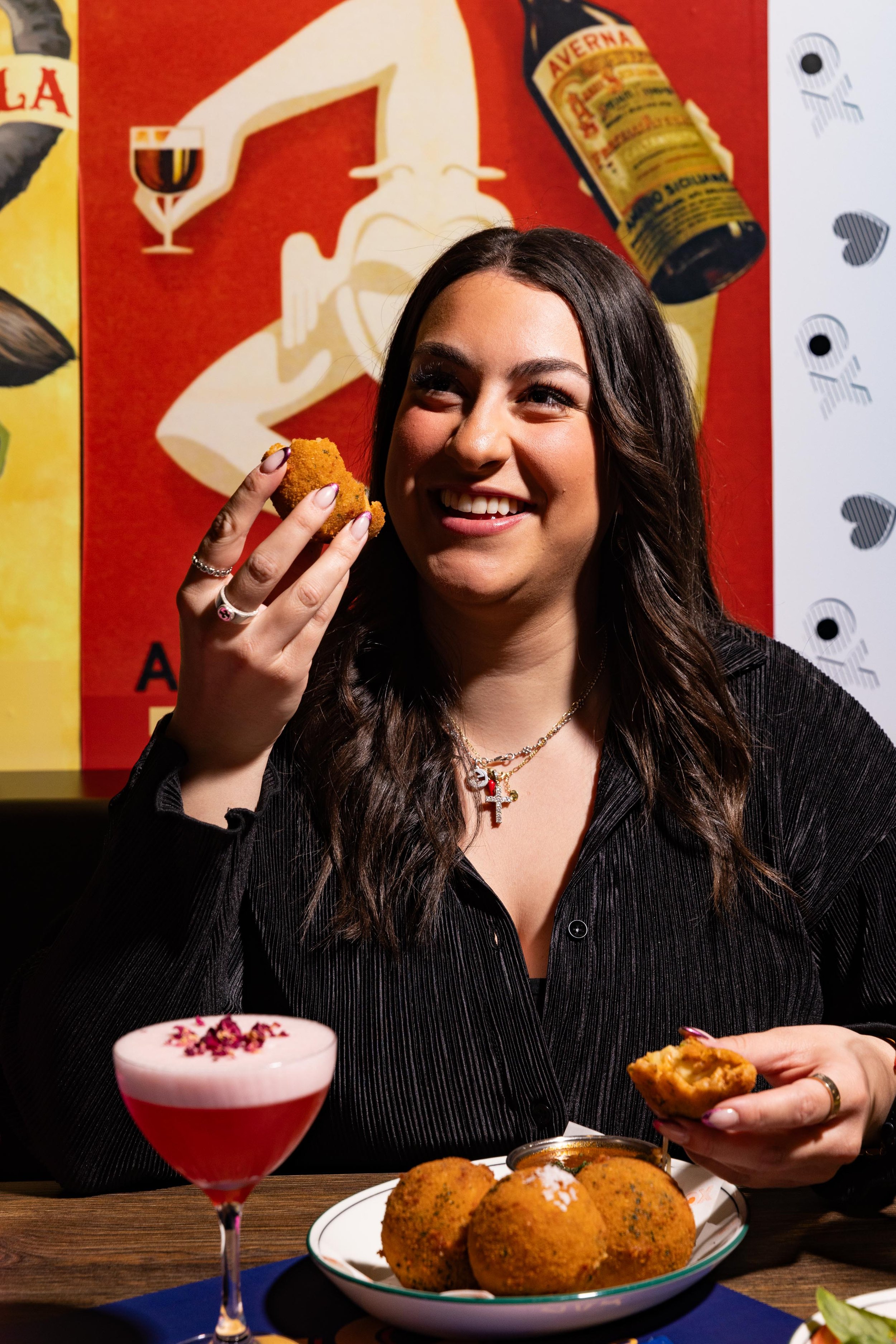 Girl enjoying a classic Italian dish of Arancini | A dish featured on the Tocca Werribee Functions Set Menu