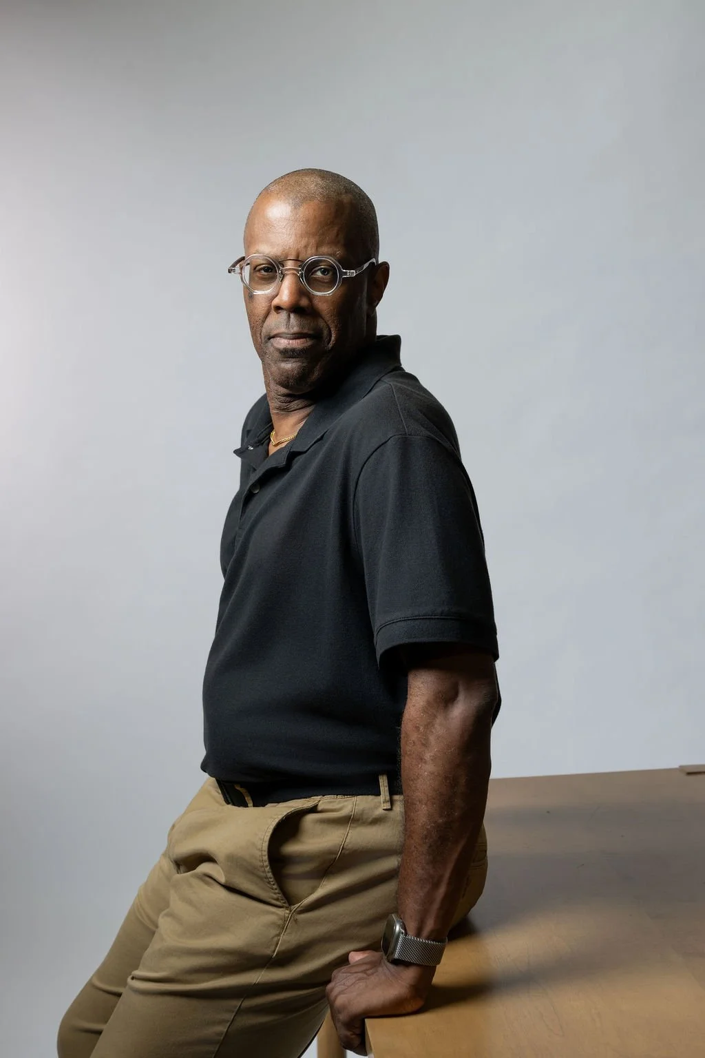 Richard Taliaferro, career coach for mid-career professionals, journalists, and editors, standing in a studio portrait against a gray background.