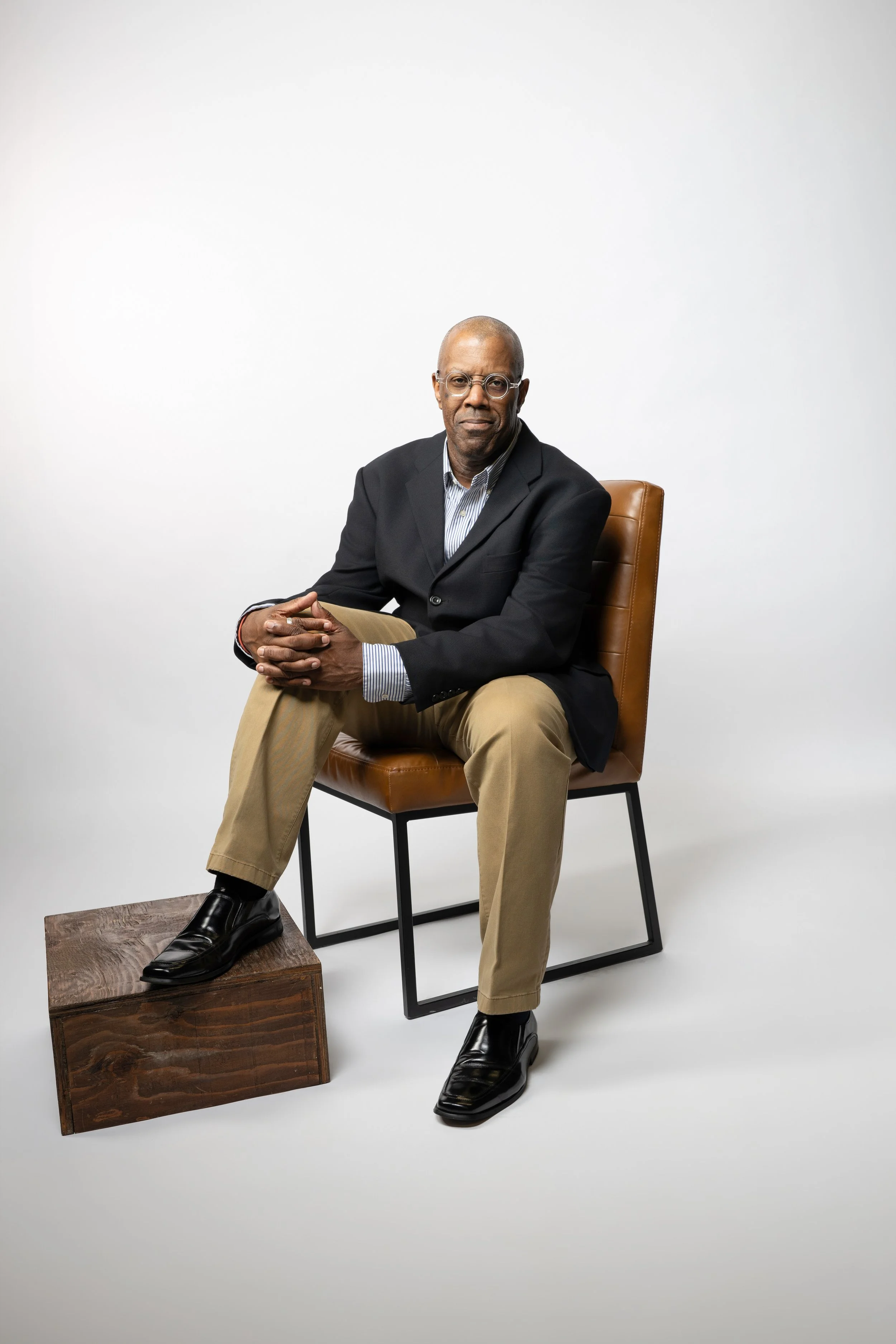 Richard Taliaferro, career coach for mid-career professionals, journalists, and editors, seated in a studio portrait.