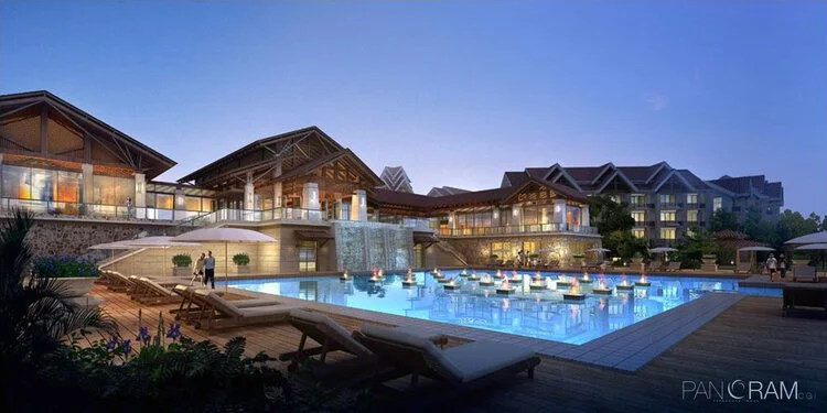 Nighttime view of a resort with a pool
