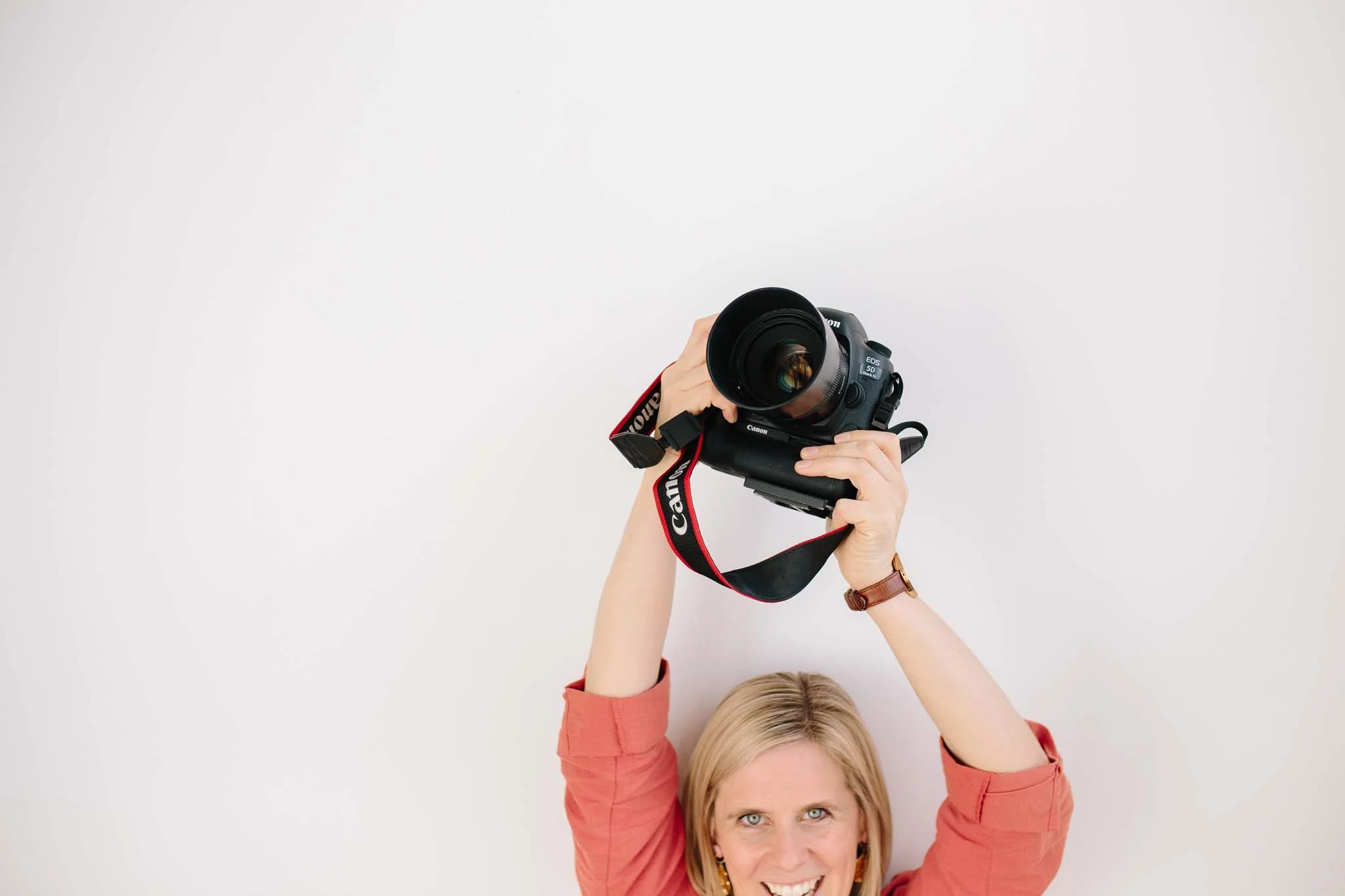 Melbourne branding photographer Gemma Carr holding camera overhead