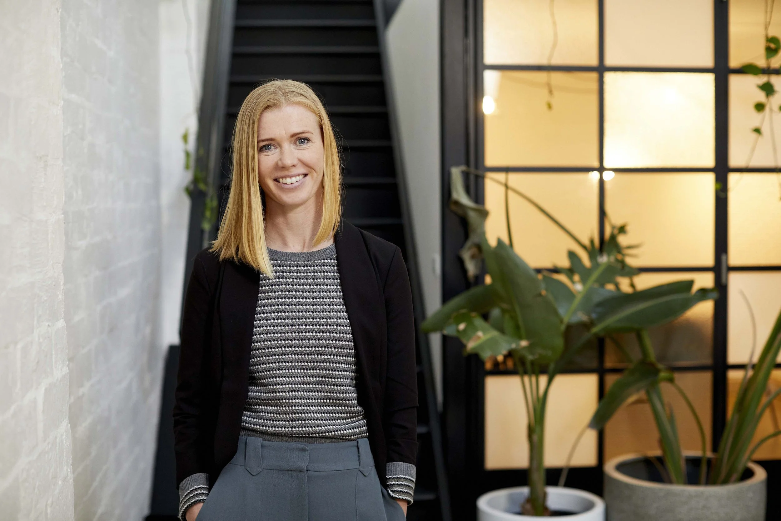 Melbourne headshot photography woman in blazer by white brick wall