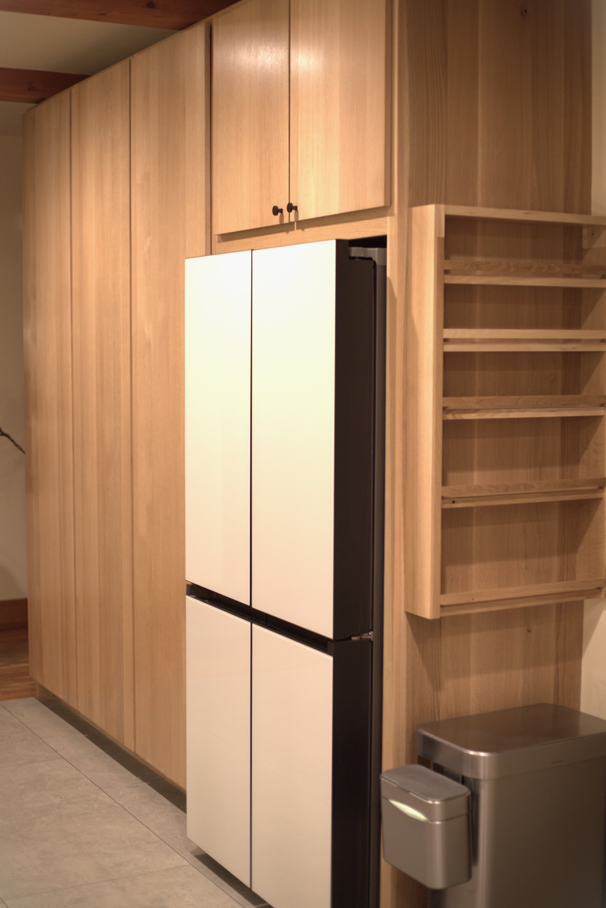 Rift sawn white oak slab cabinetry with hand made white oak spice rack