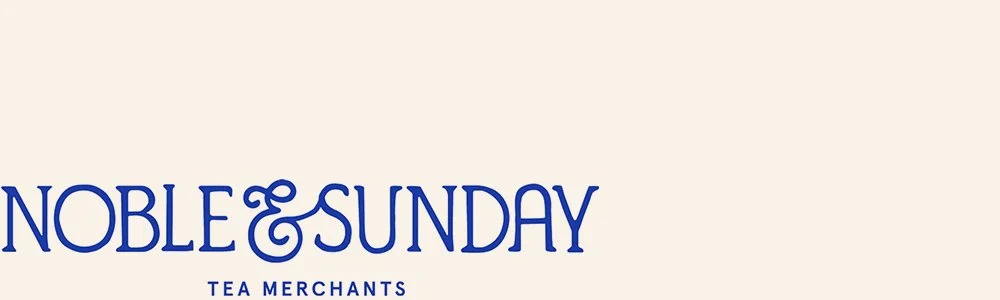 Logo for Noble & Sunday Tea Merchants in blue text on a beige background.