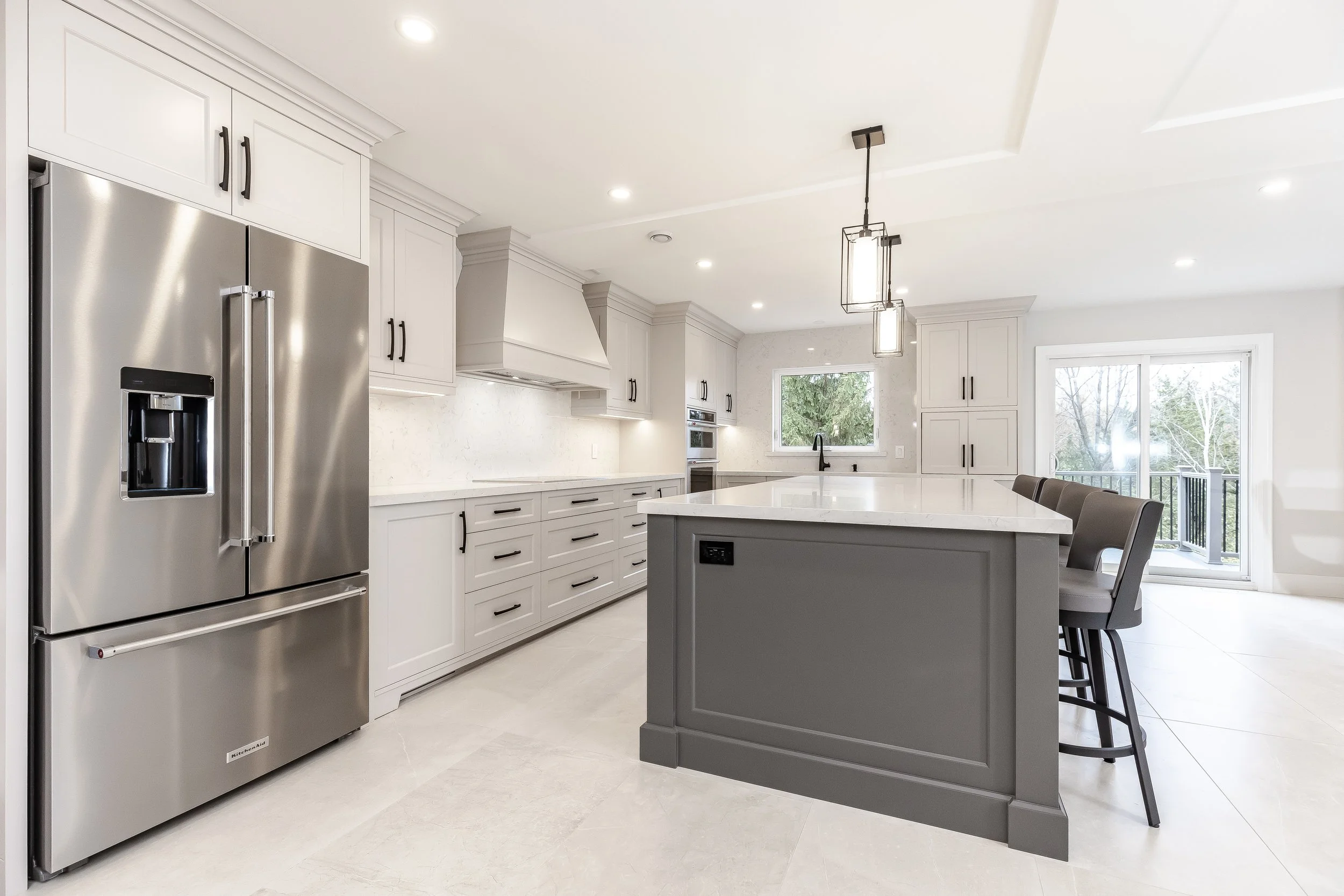 Custom transitional kitchen with island and painted cabinetry by Metrico