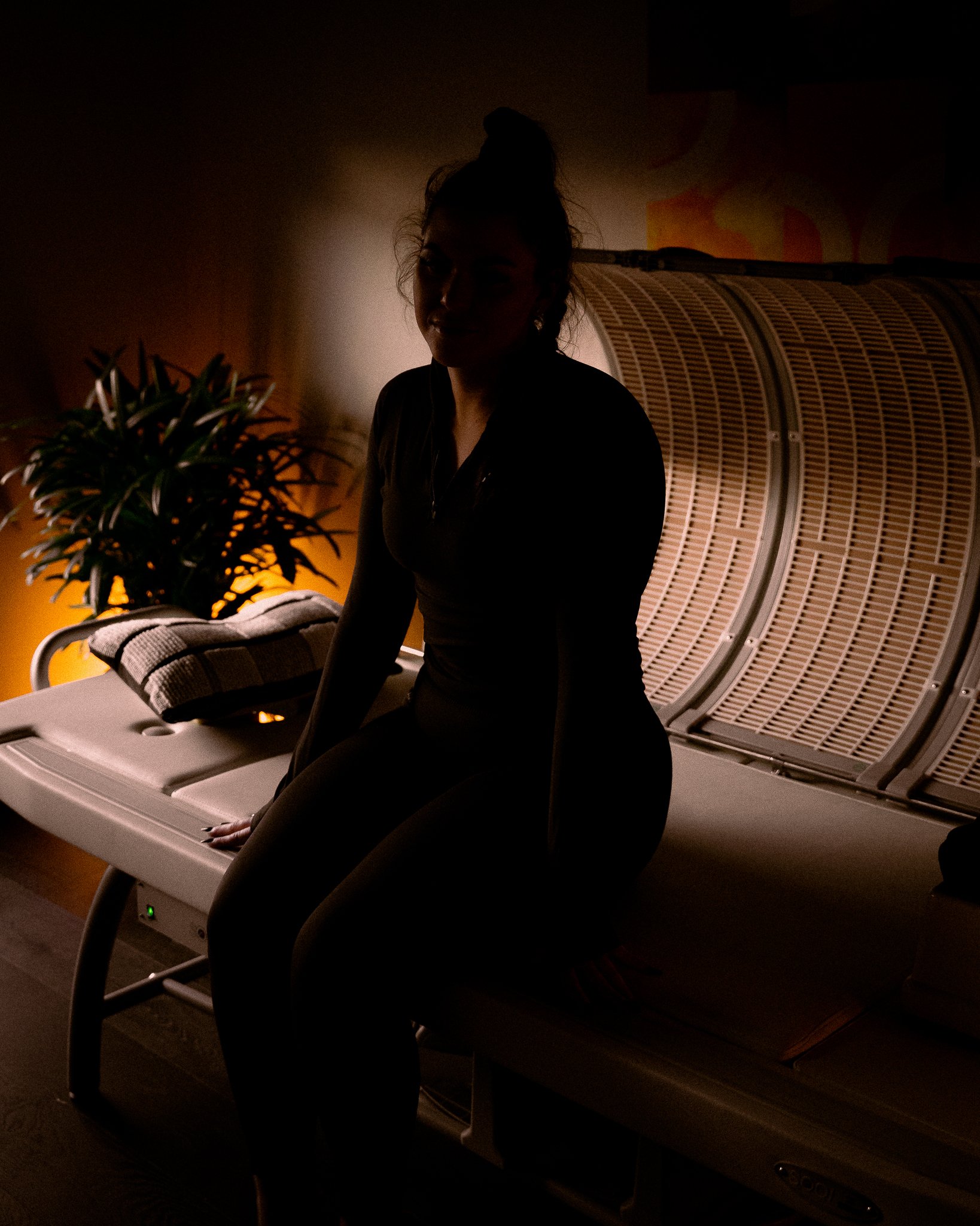 Woman sitting on edge of SOQI Bed