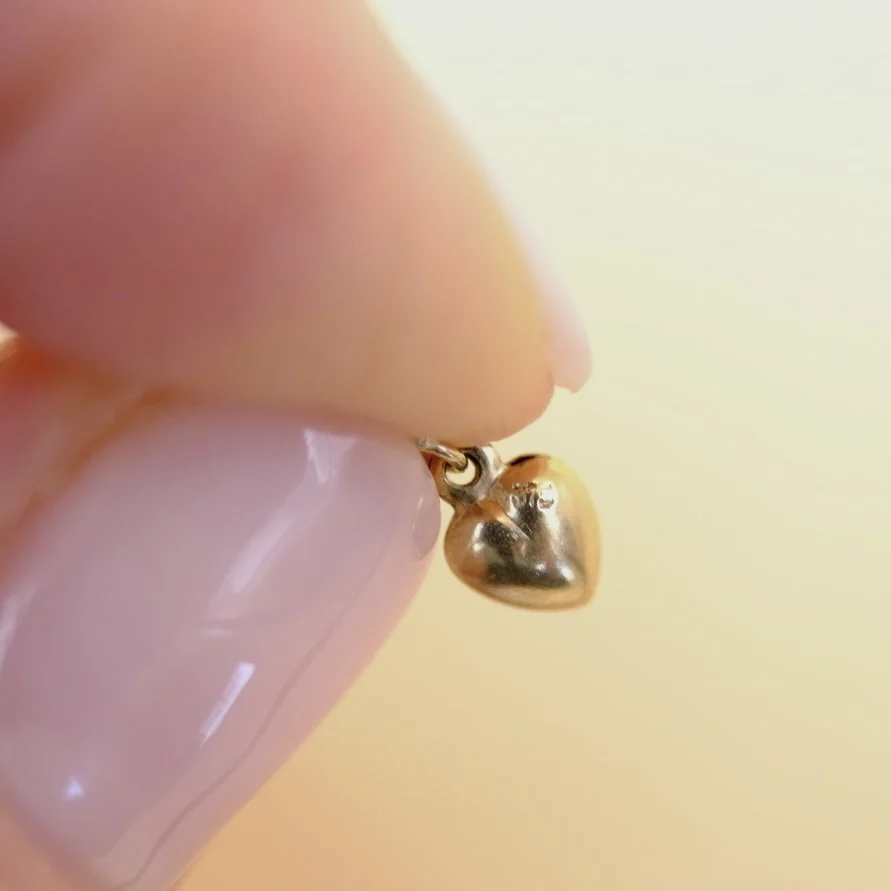 BVL1140-tiny-gold-hearts-charm-held.jpg