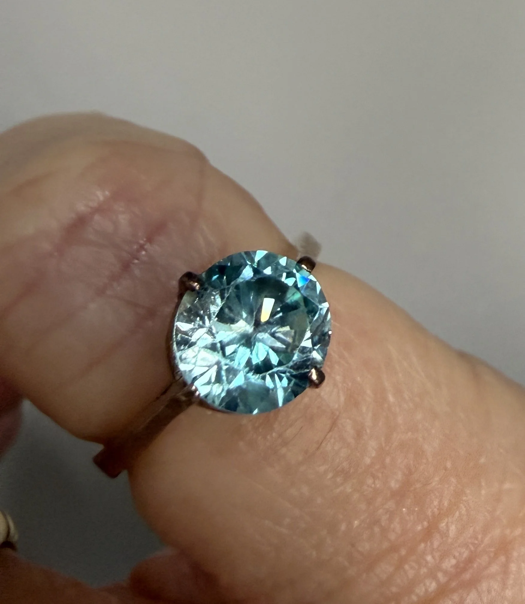 BVL1055-blue-zircon-solitaire-ring-worn.jpg