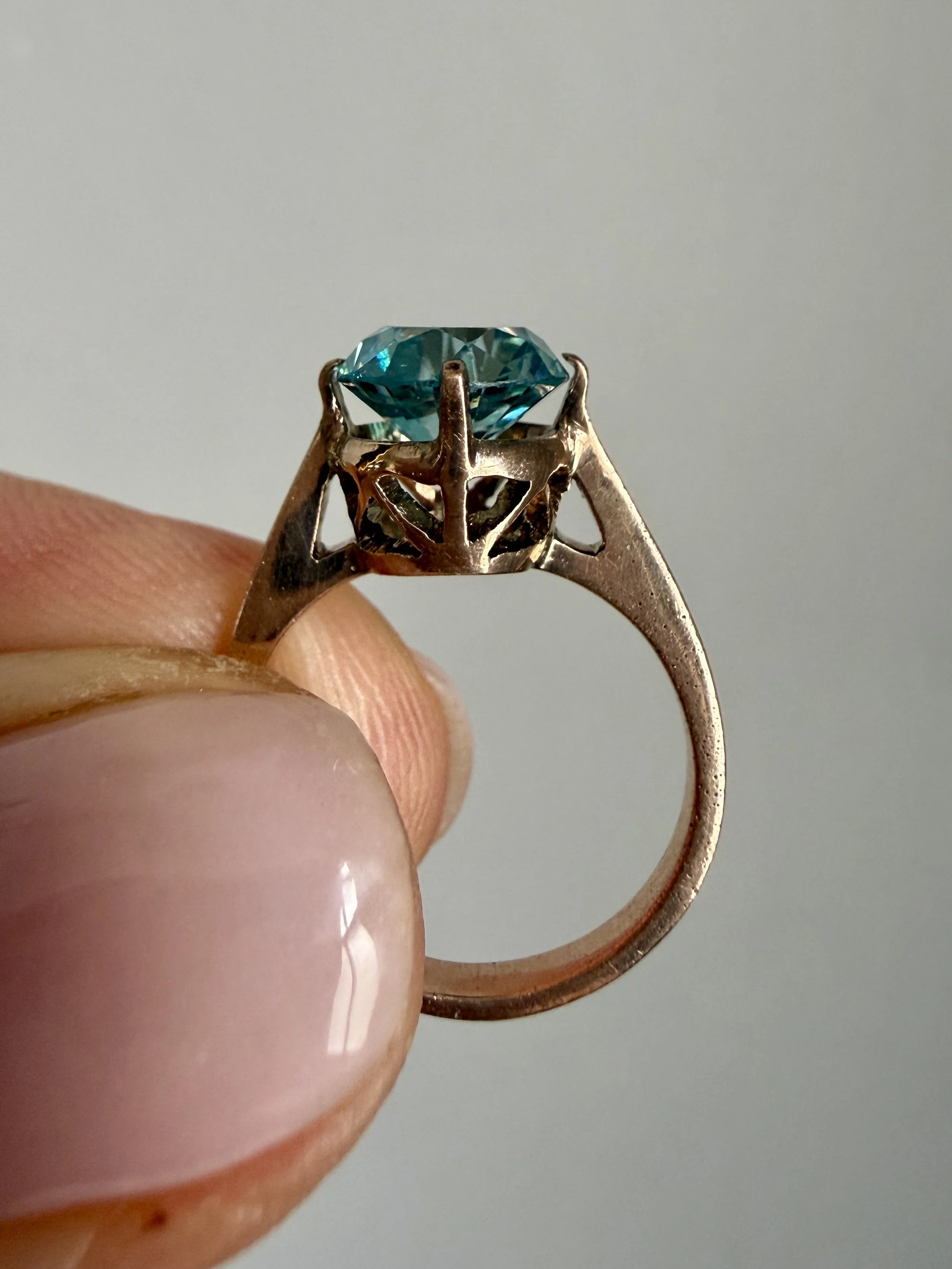 BVL1055-blue-zircon-solitaire-ring-heldside.jpg