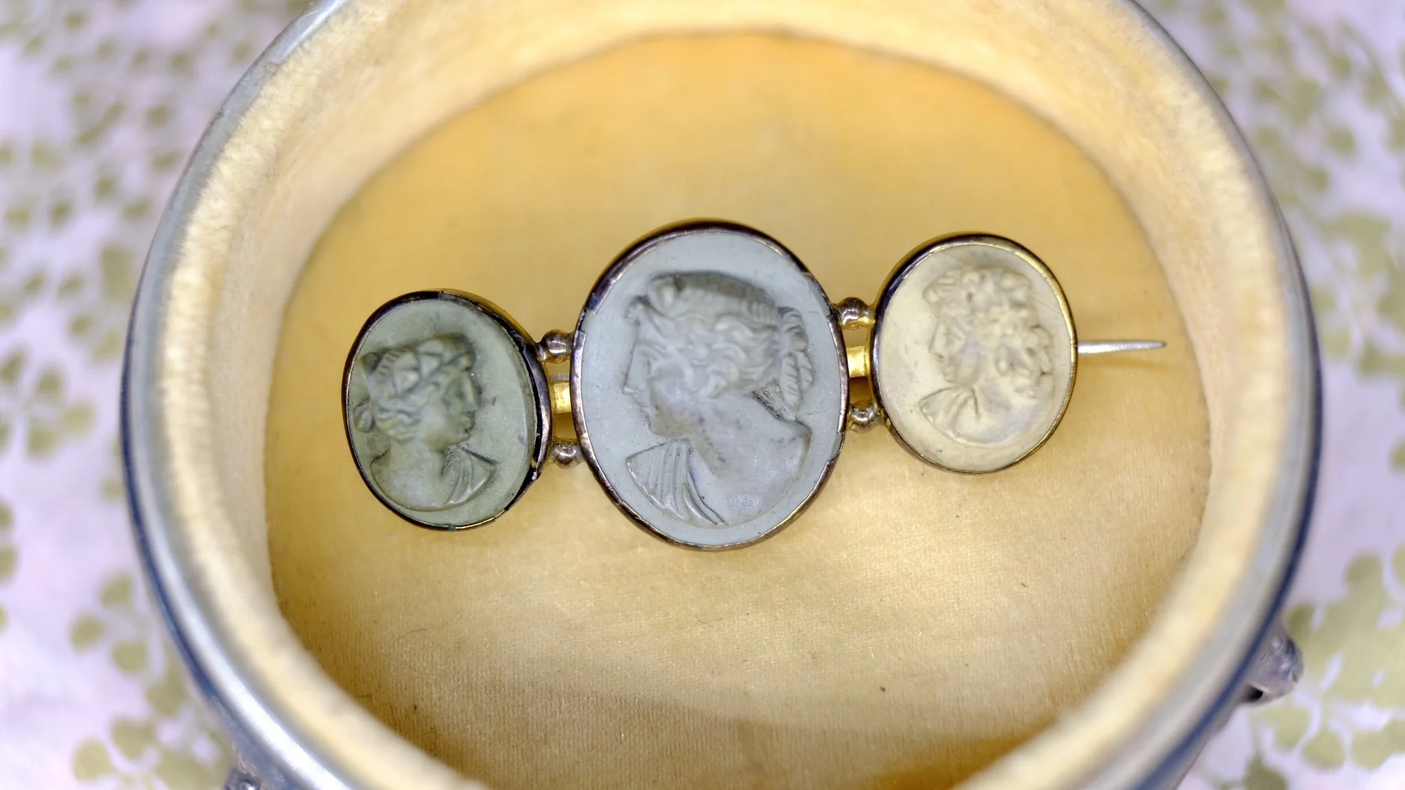 A fabulous grand tour antique lava brooch of three cameos depicting three maidens or goddesses