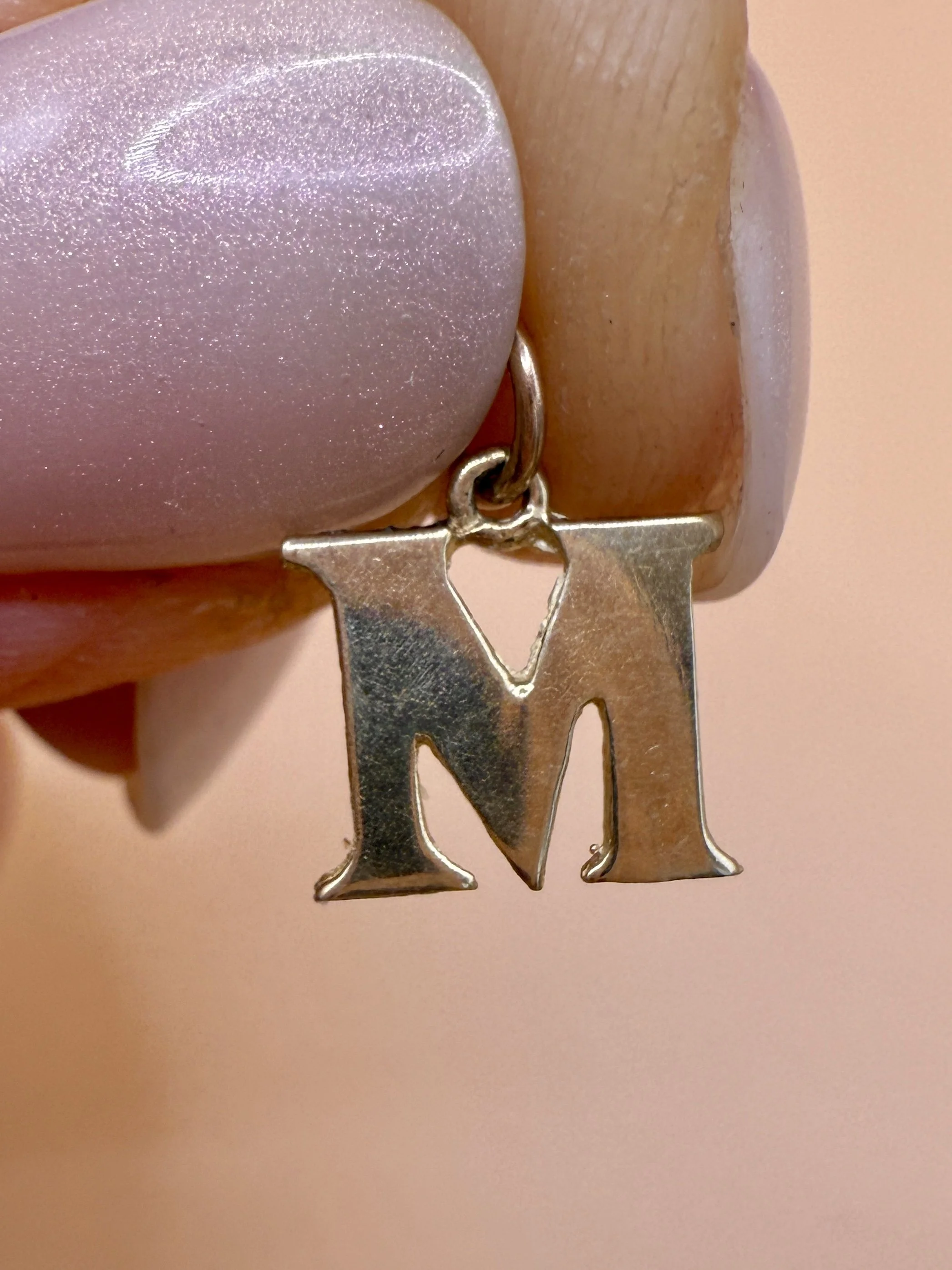 BVL1030-9ct-M-charm-held.jpg