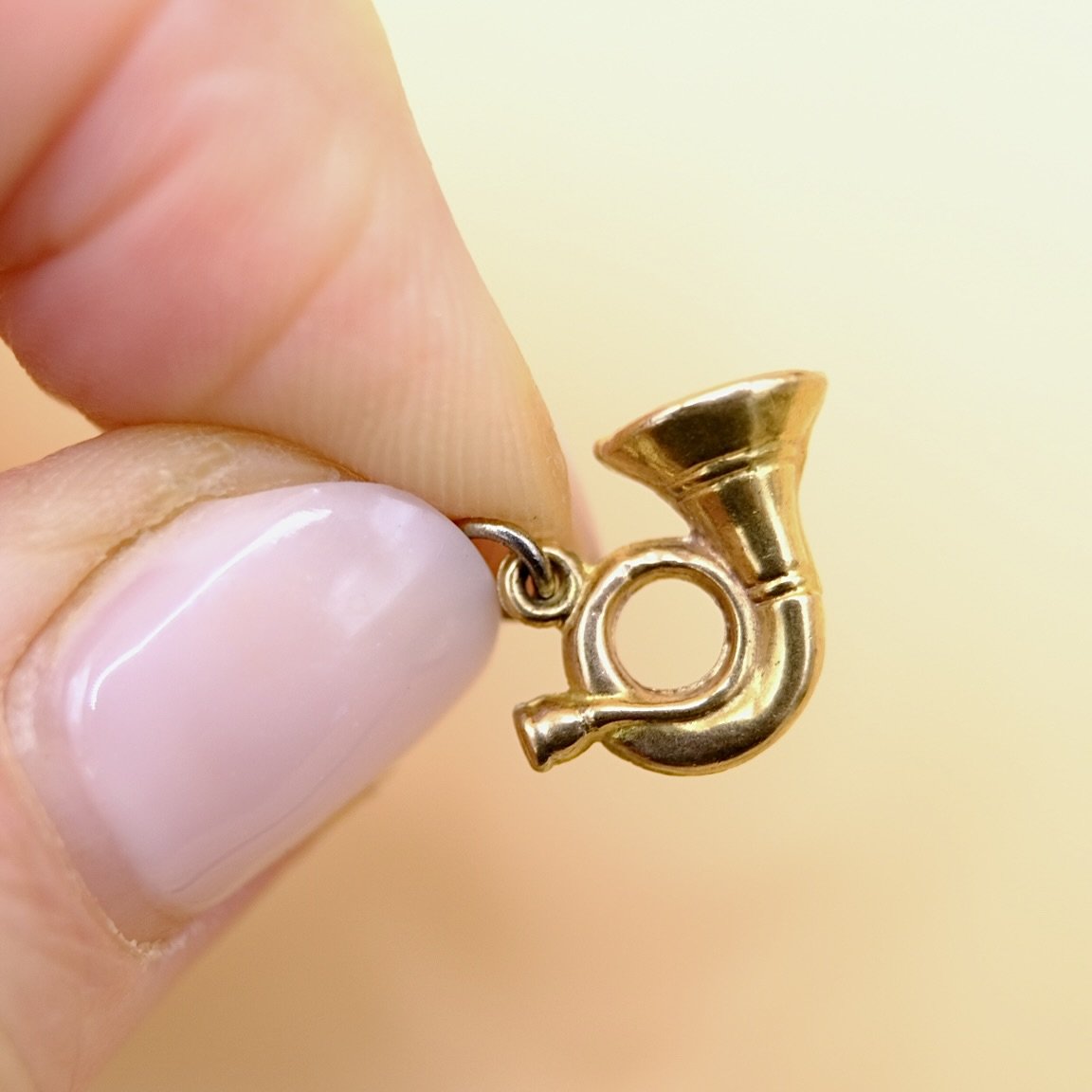 BVL1091-9ct-bugle-charm-held.jpg