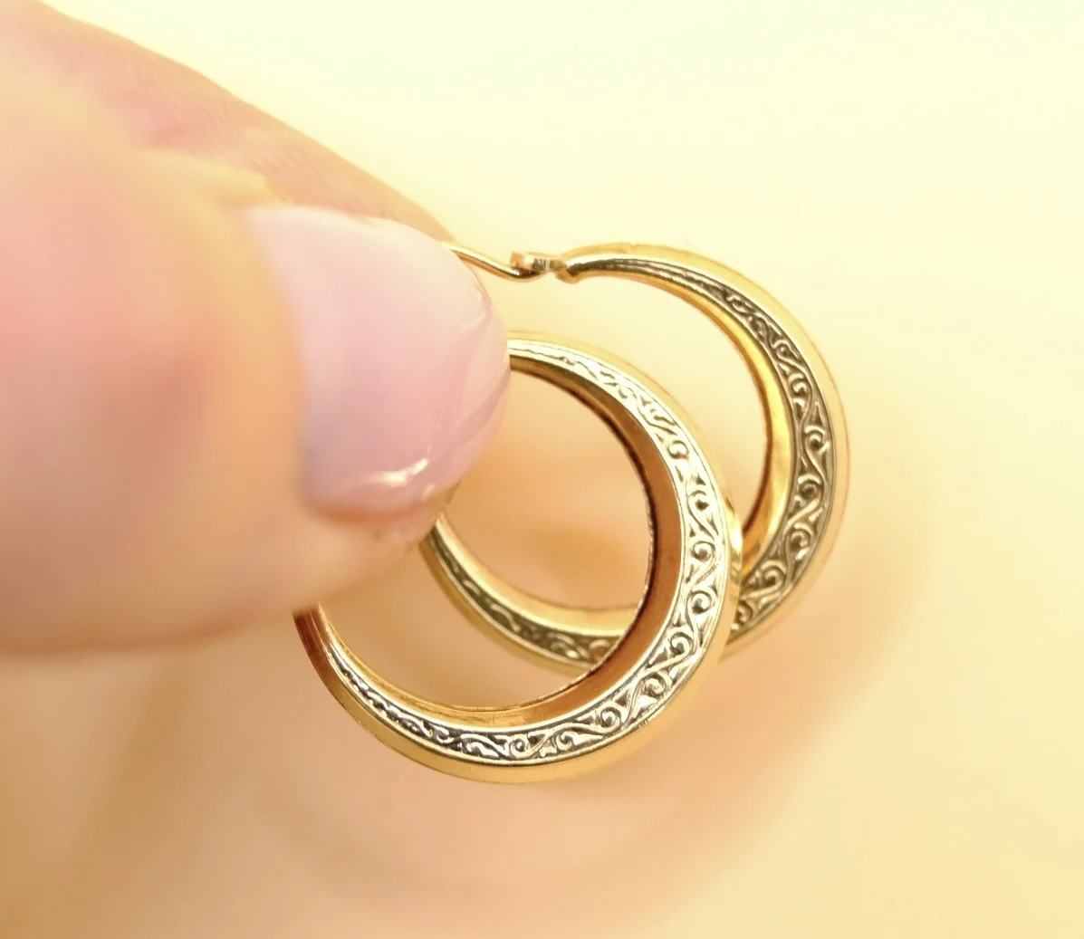BVL1148-gold-engraved-hoop-earrings-held.jpg