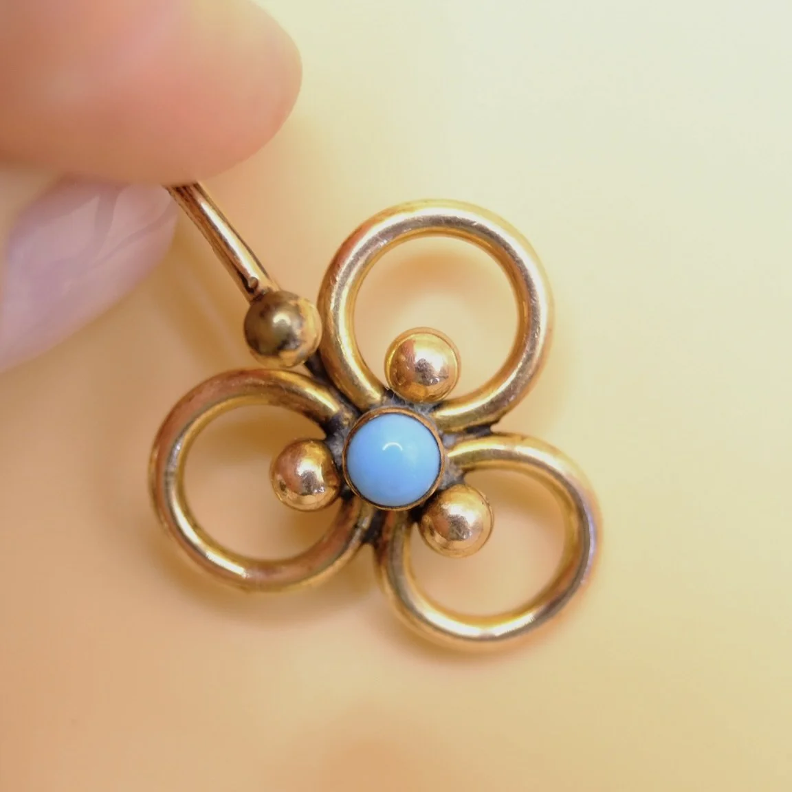 BVL845-turquoise-bead-trefoil-pendant-held.jpg