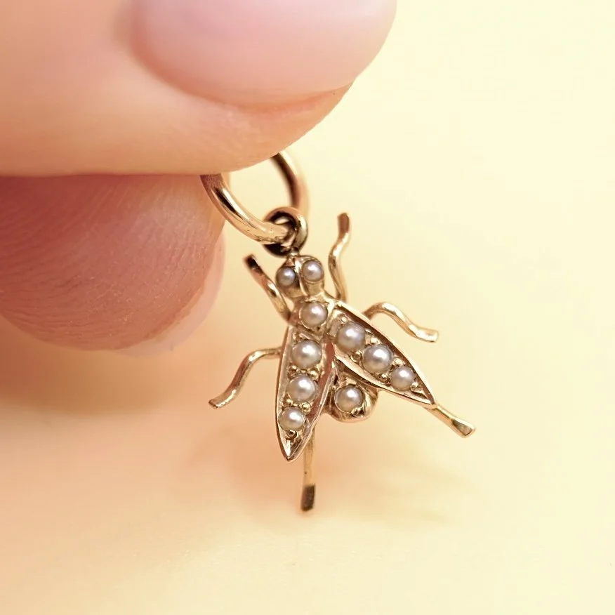 BVL1117-pearl-fly-pendant-held.jpg