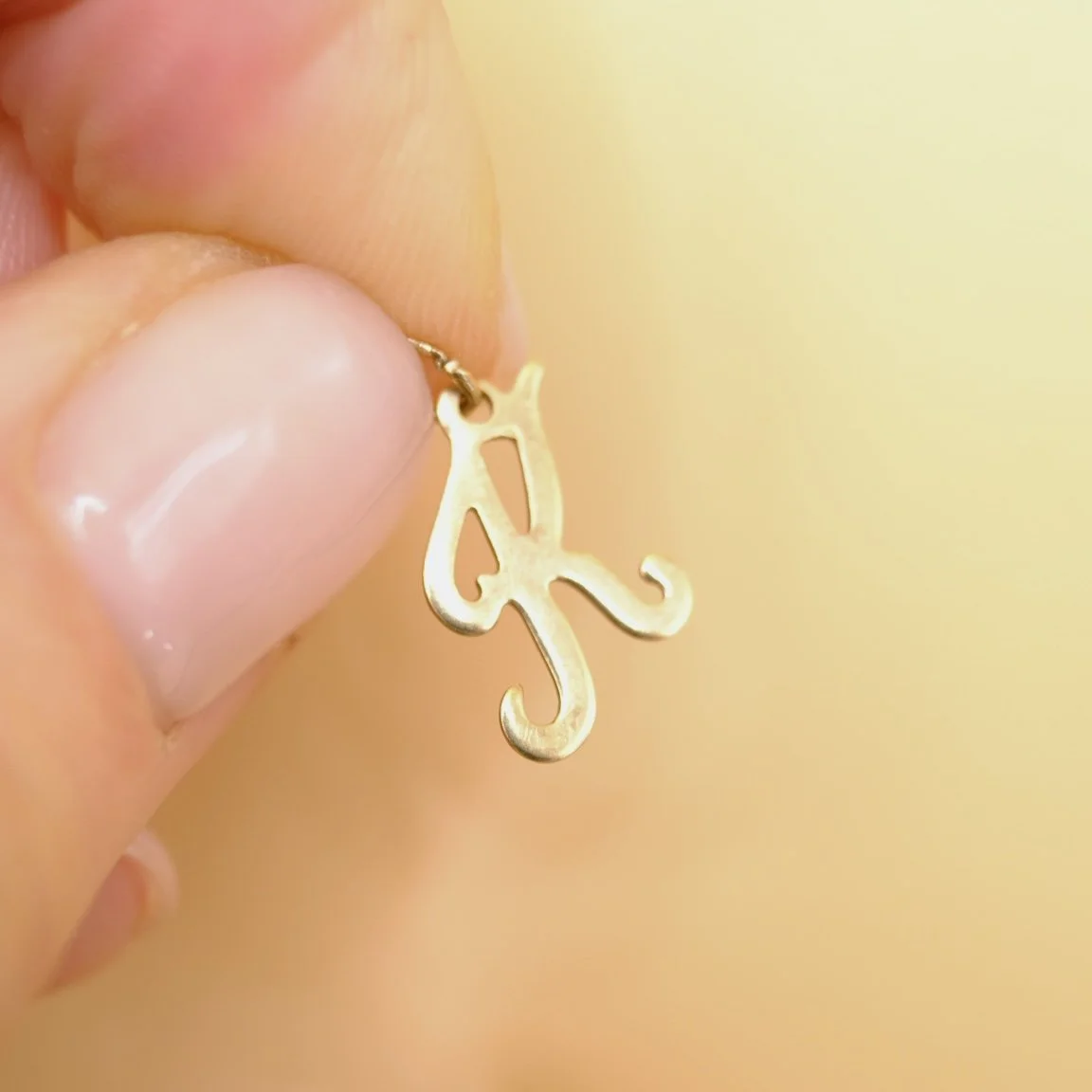 BVL1143-9ct-K-charm-held.jpg