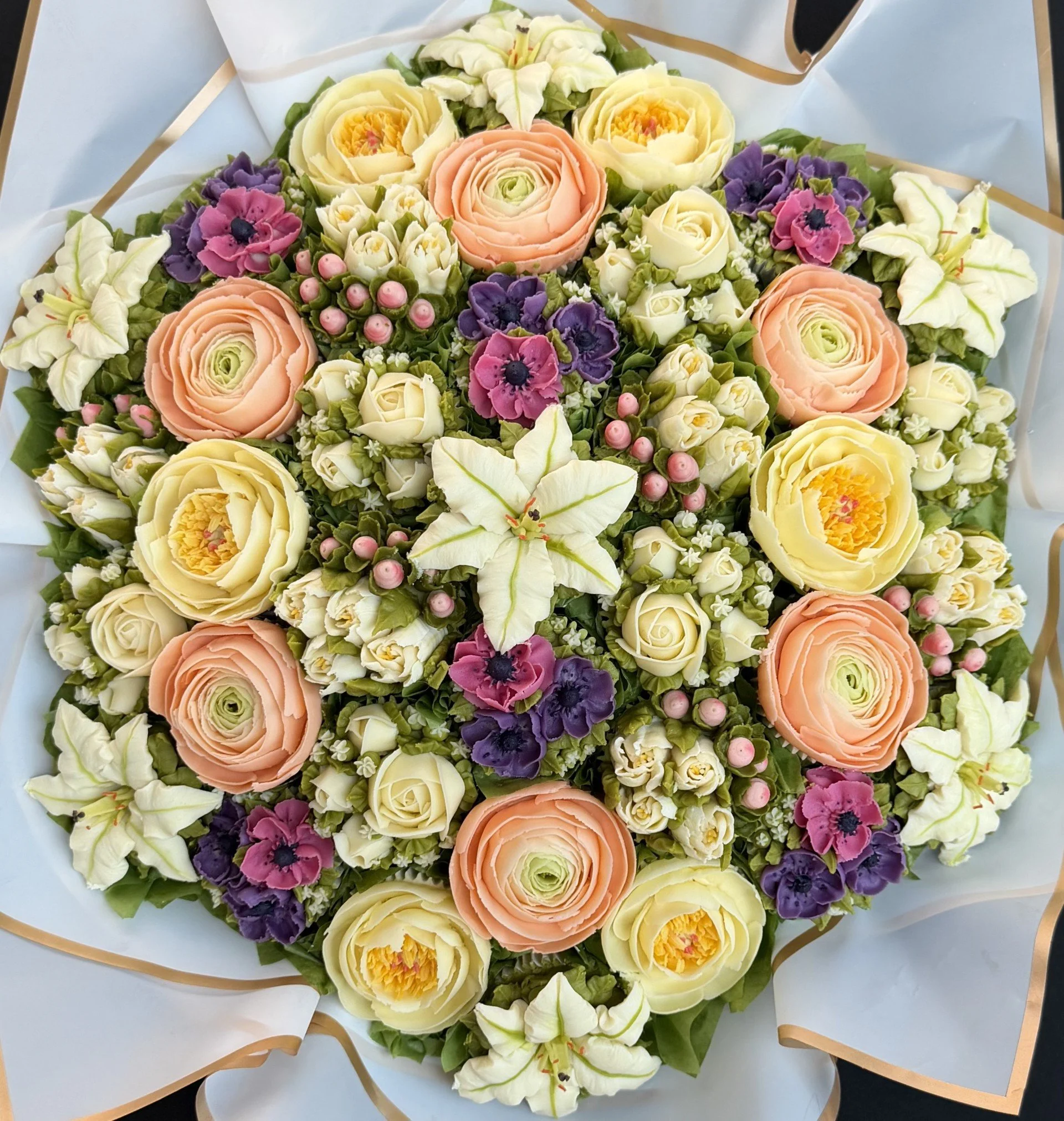 37 cupcake bouquet of 6 different blooms (55 x 55cm)
Lilies, Ranunculus and Purple Anemones