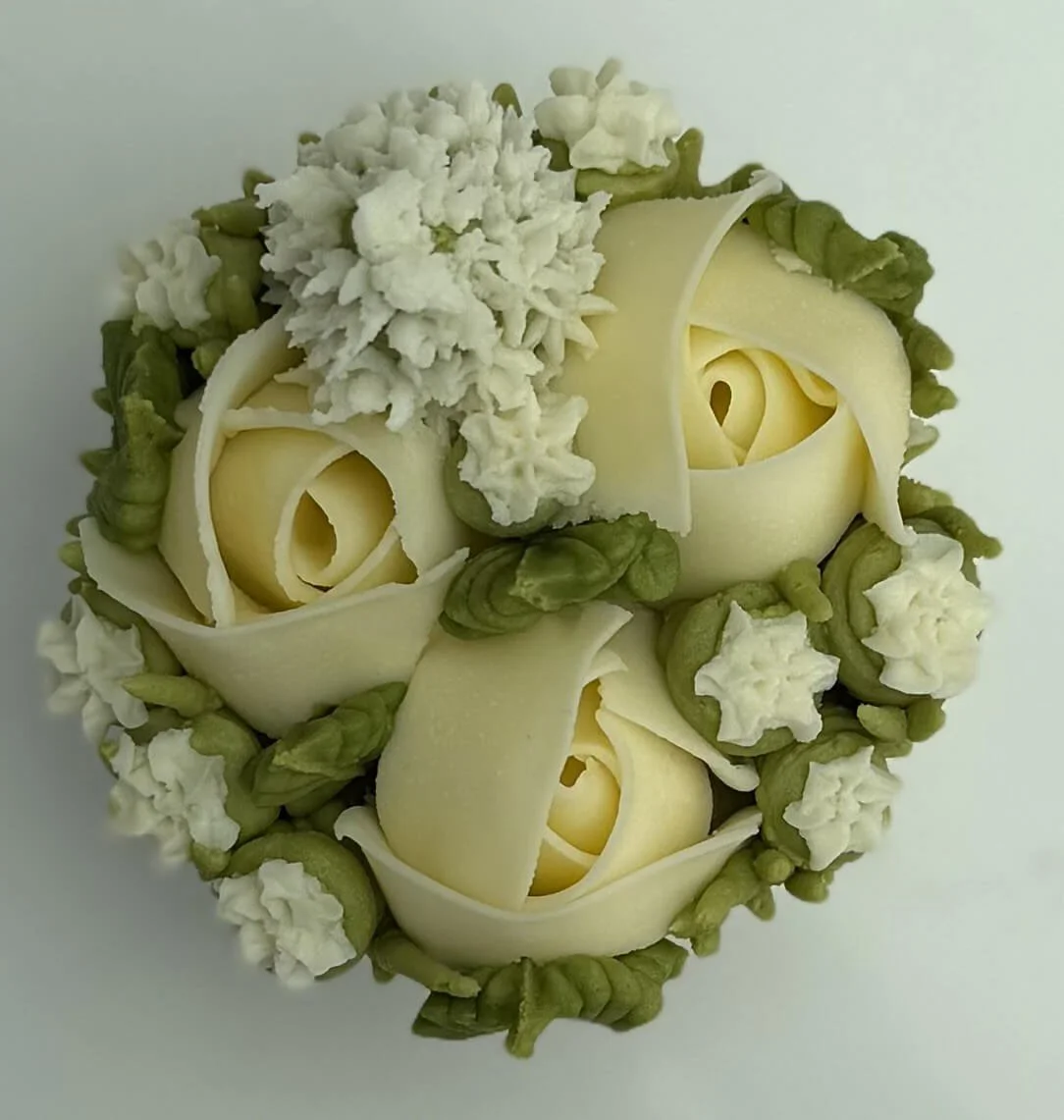Trio of rosebuds with gypsophila and white veronica cupcake