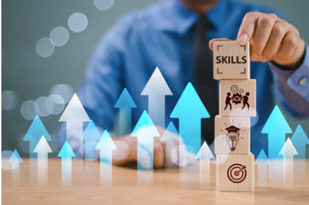 Man stacking wooden cubes with skills related icons with coloured arrows  pointing up showing progress
